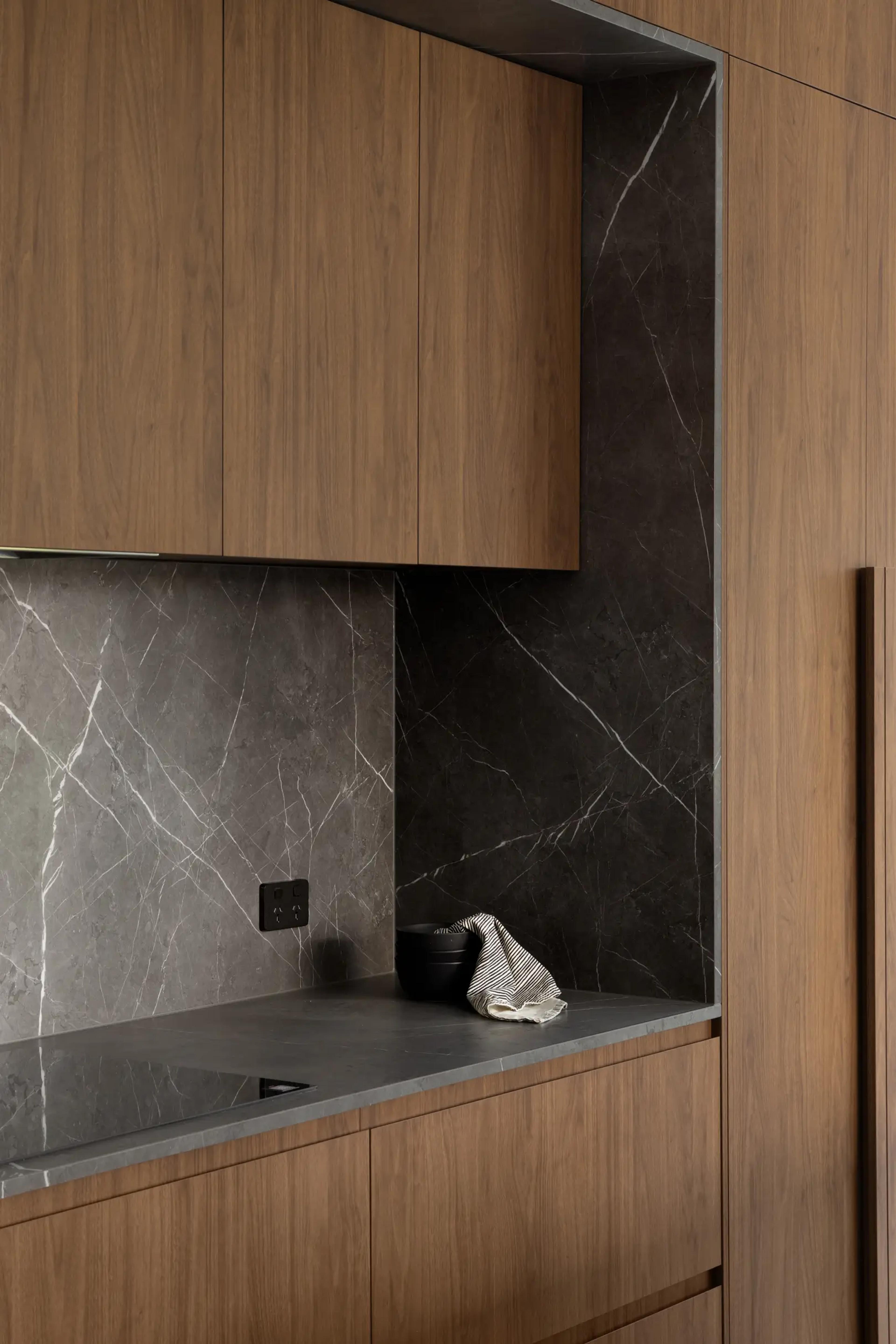 Butler pantry with dark stone and timber cabinetry