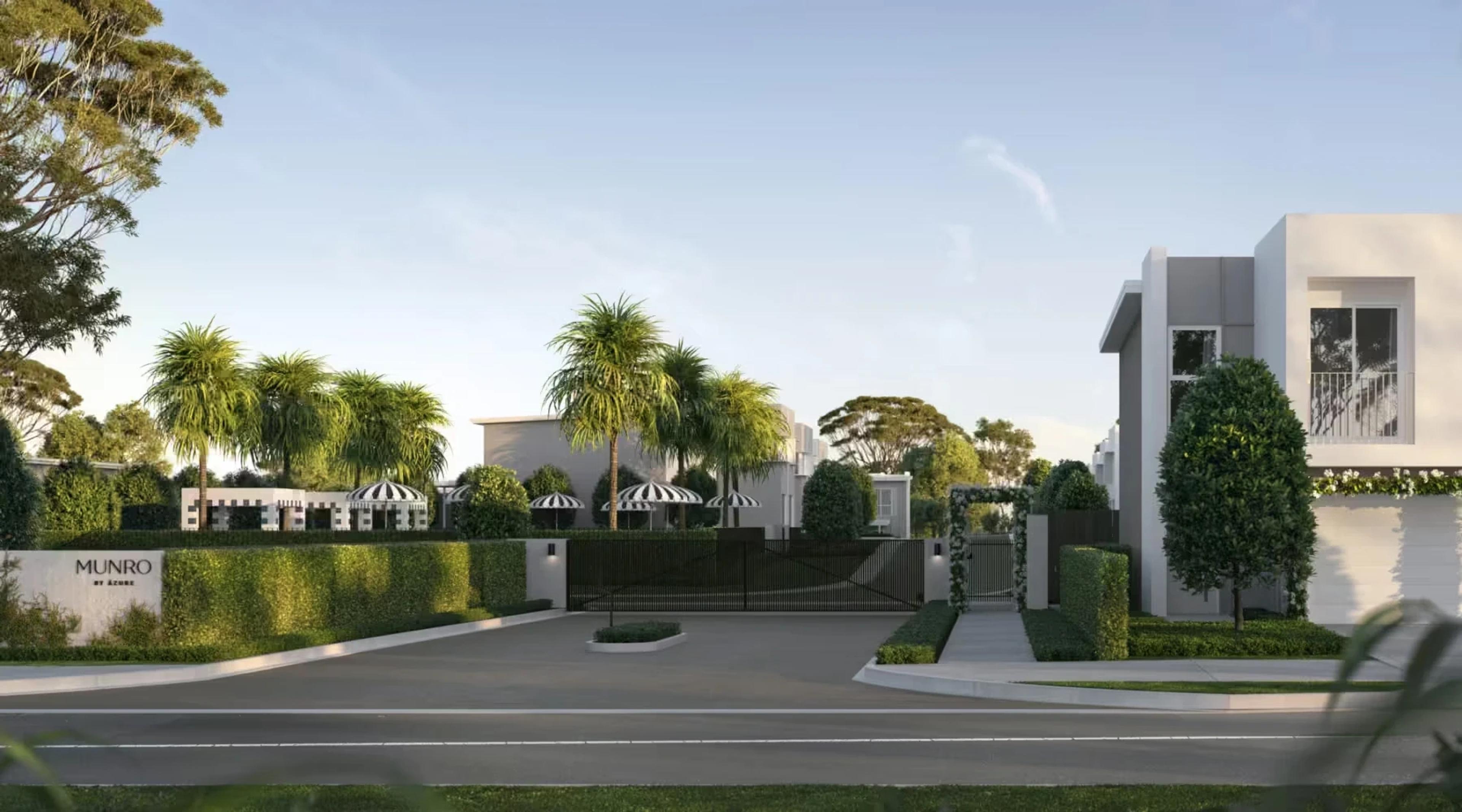 Gated street entry to Munro townhouse estate with hedging