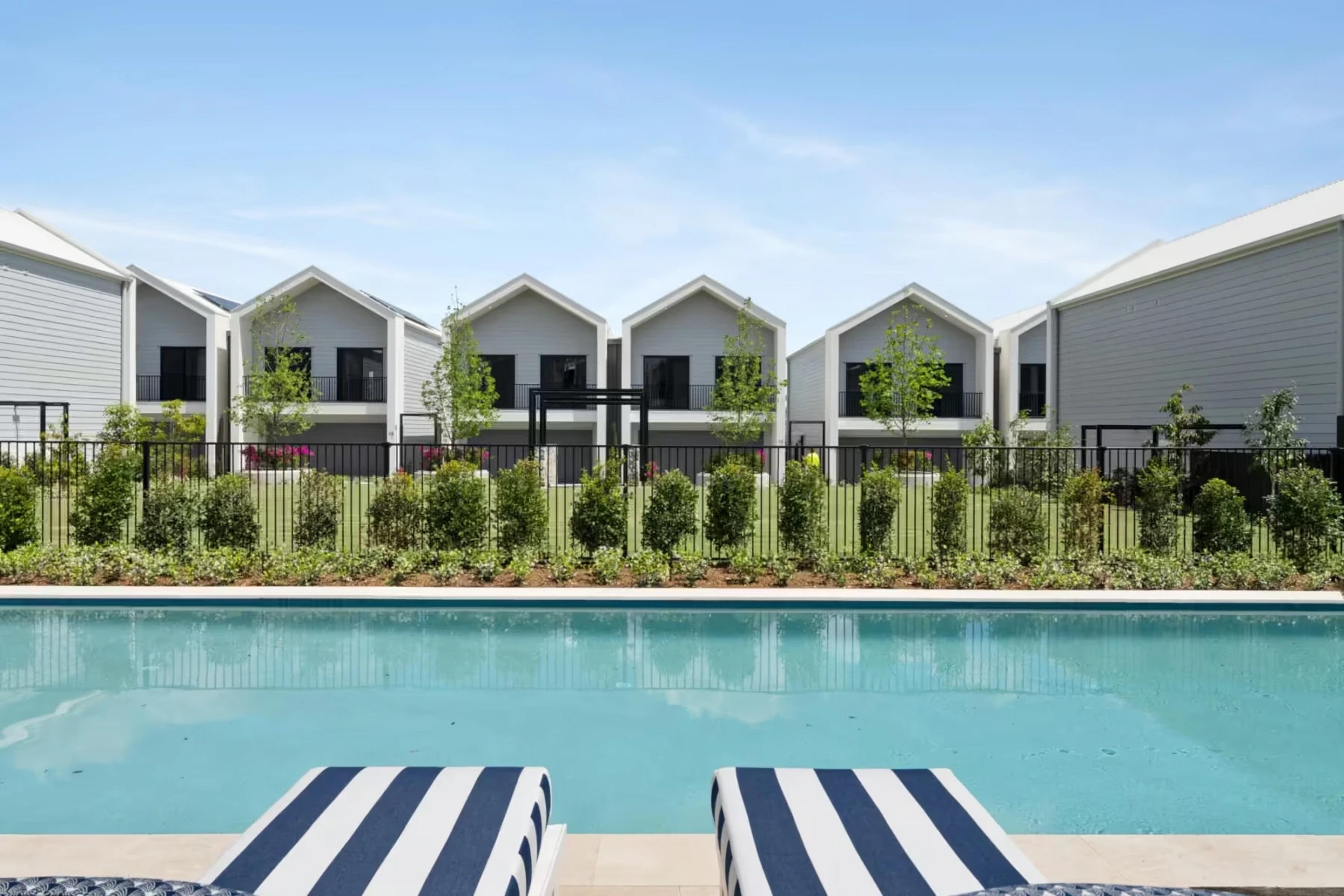 Row of gabled townhouses viewed across the pool