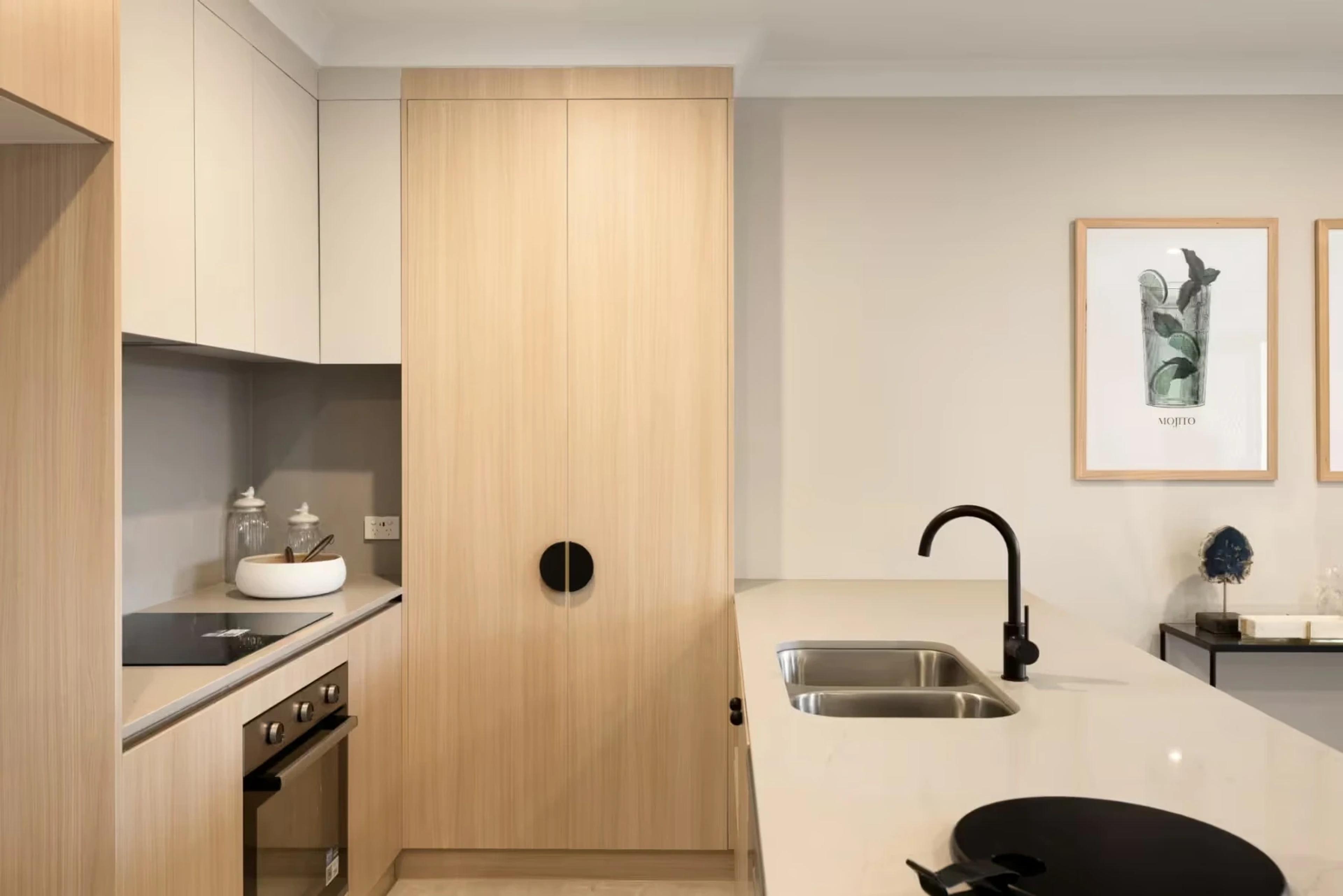 Kitchen with timber cabinetry and stone benchtop