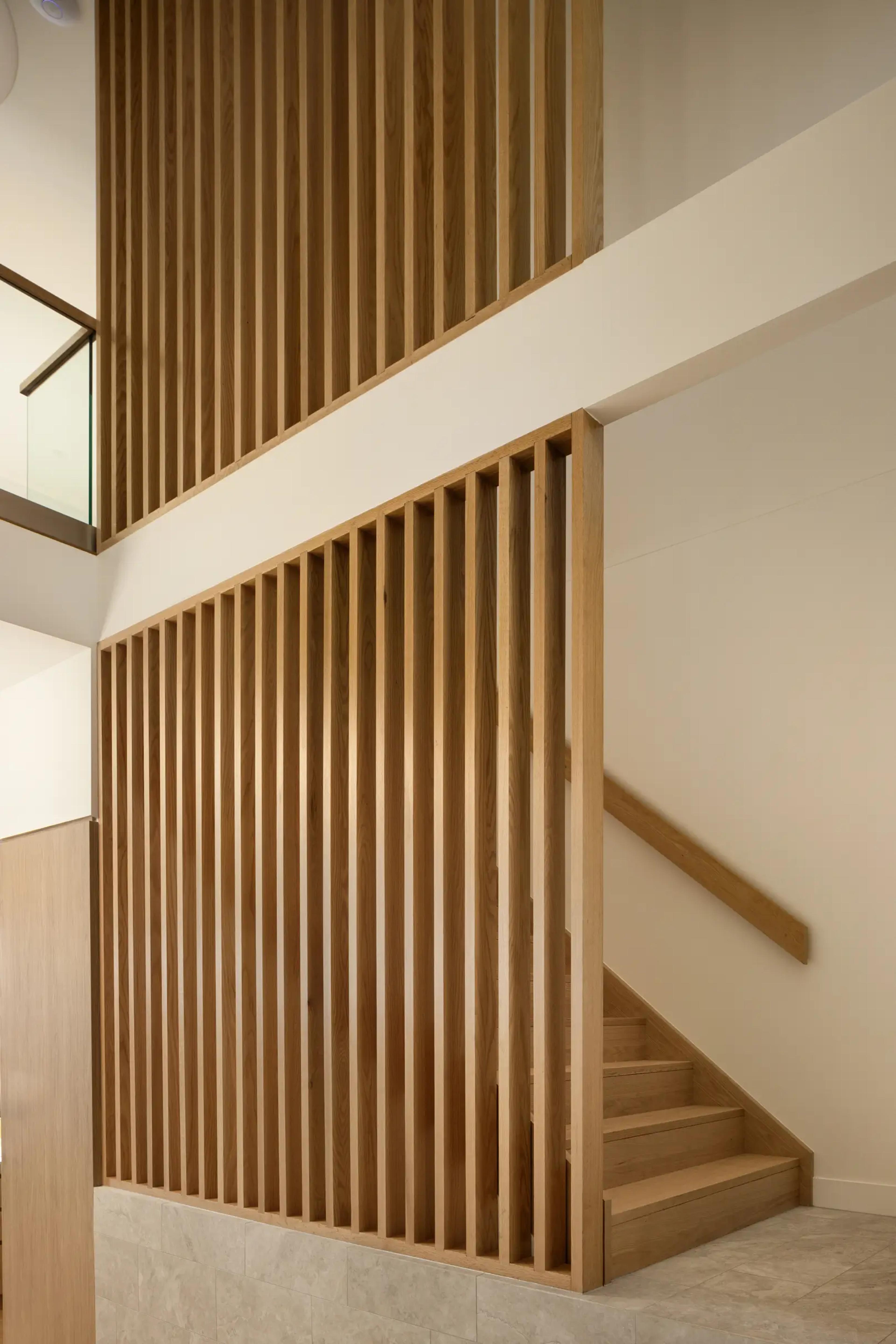 Timber slatted stair void with glass balustrade