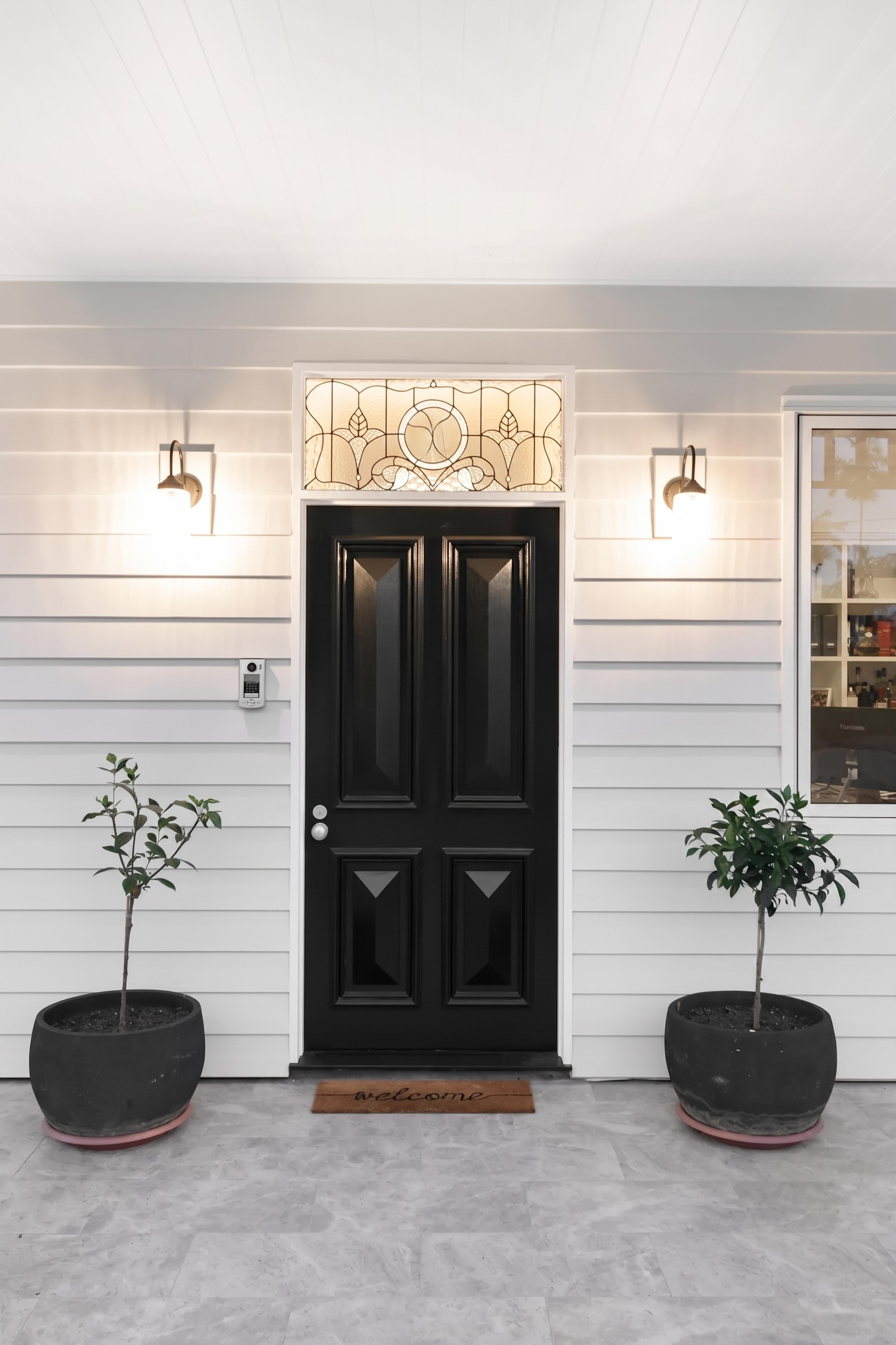 Front entry with black door and leadlight fanlight