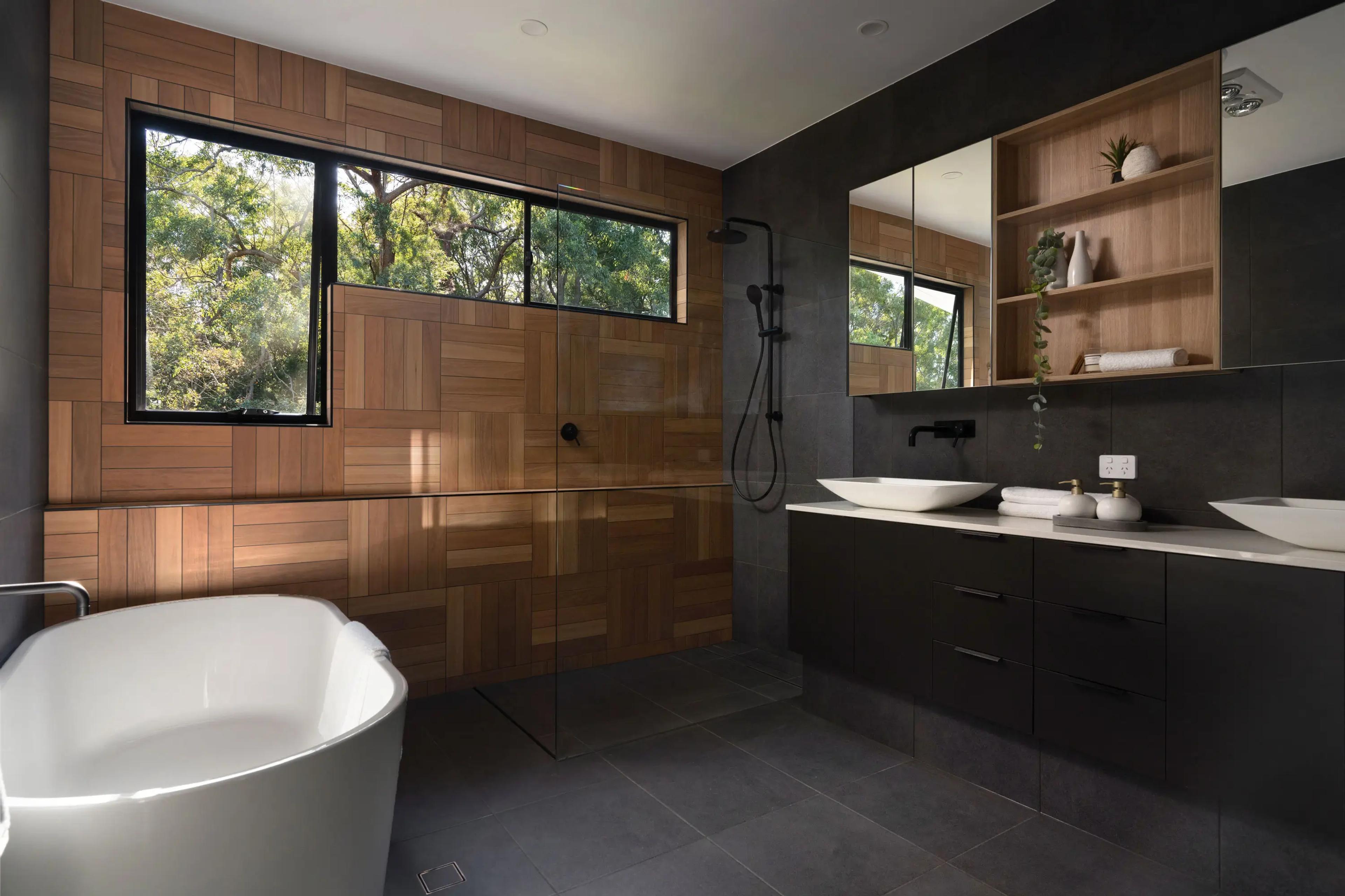Ensuite with freestanding bath, timber wall and twin basins