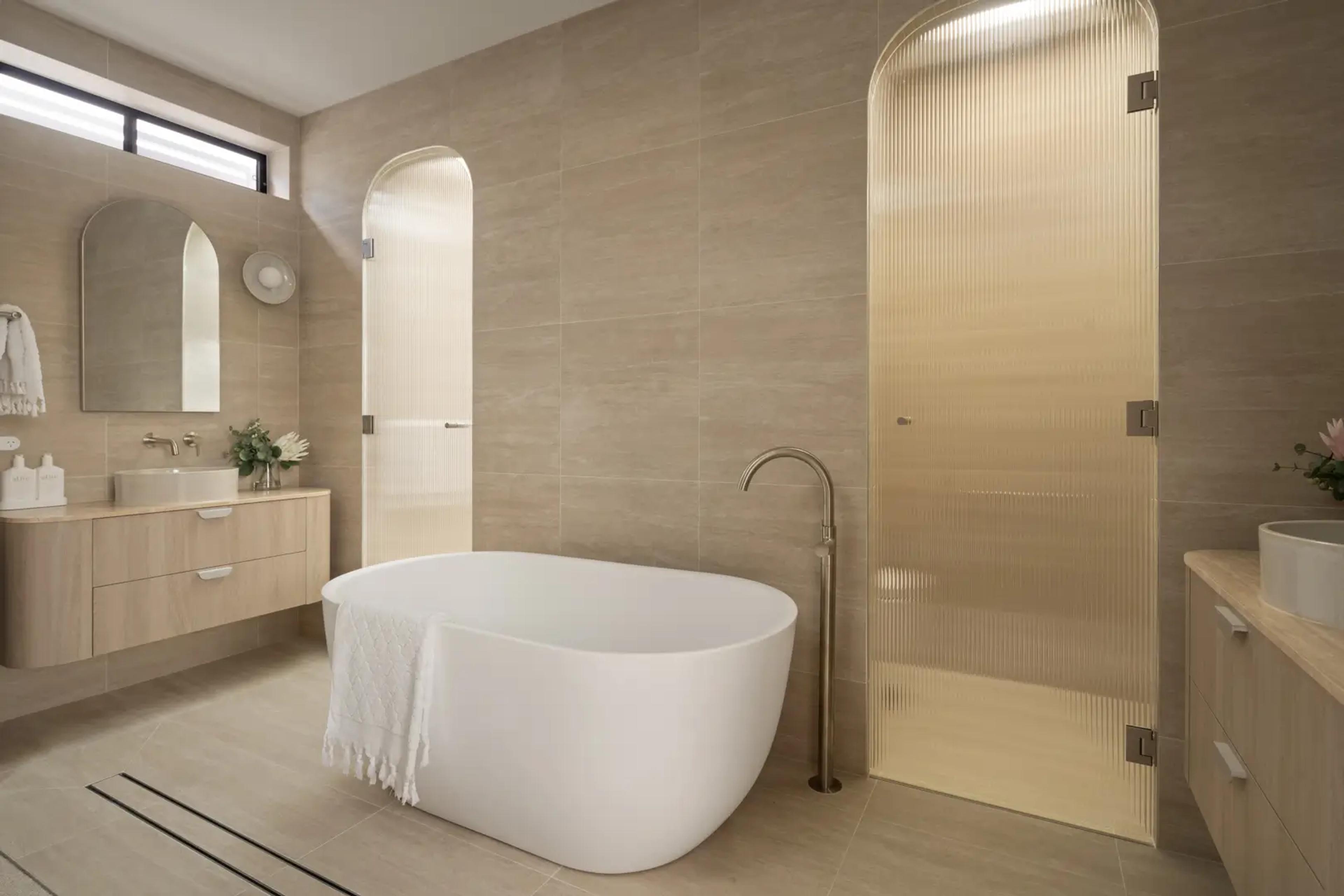 Bathroom with freestanding bath and fluted glass shower