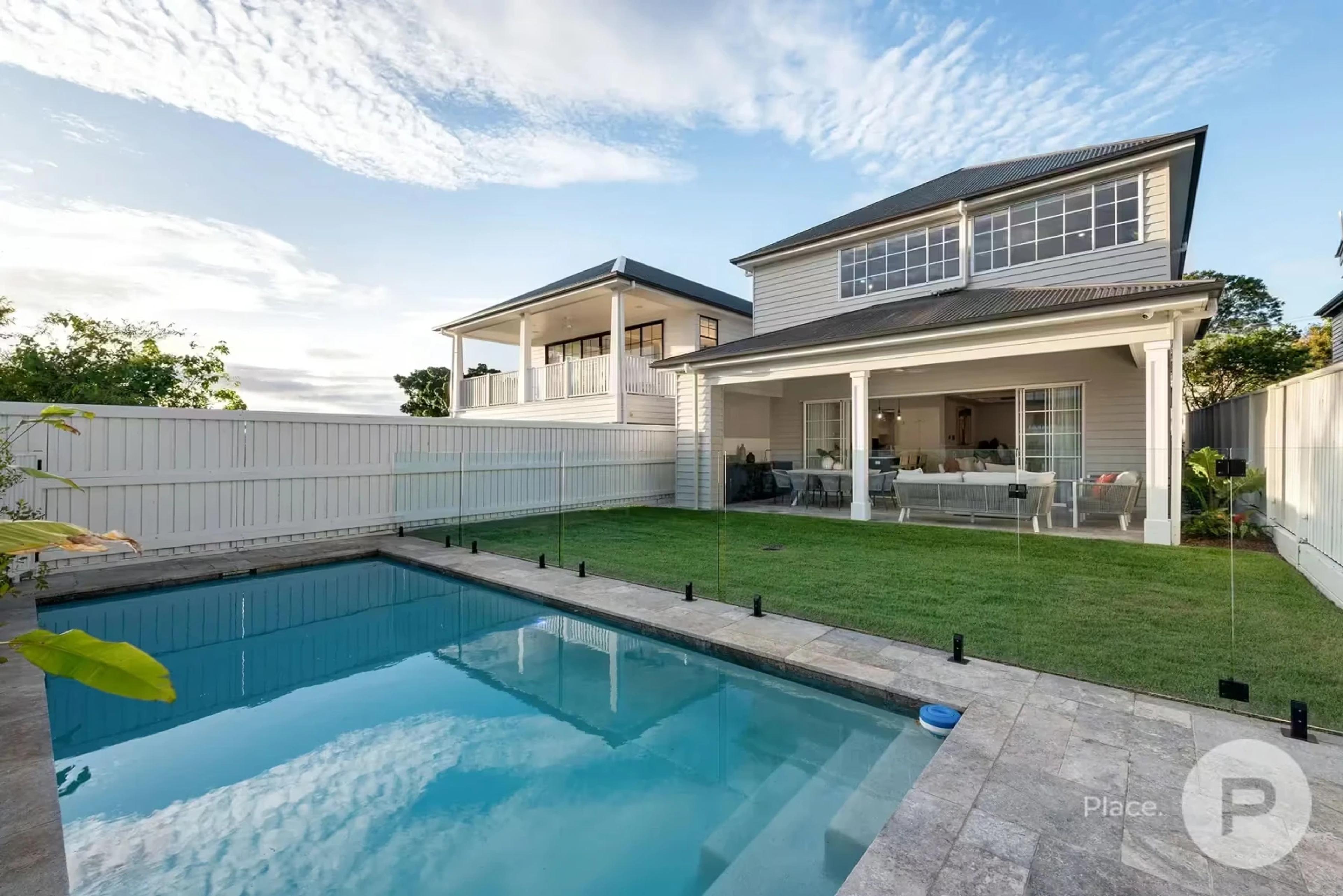 Rear yard with pool and two storey home
