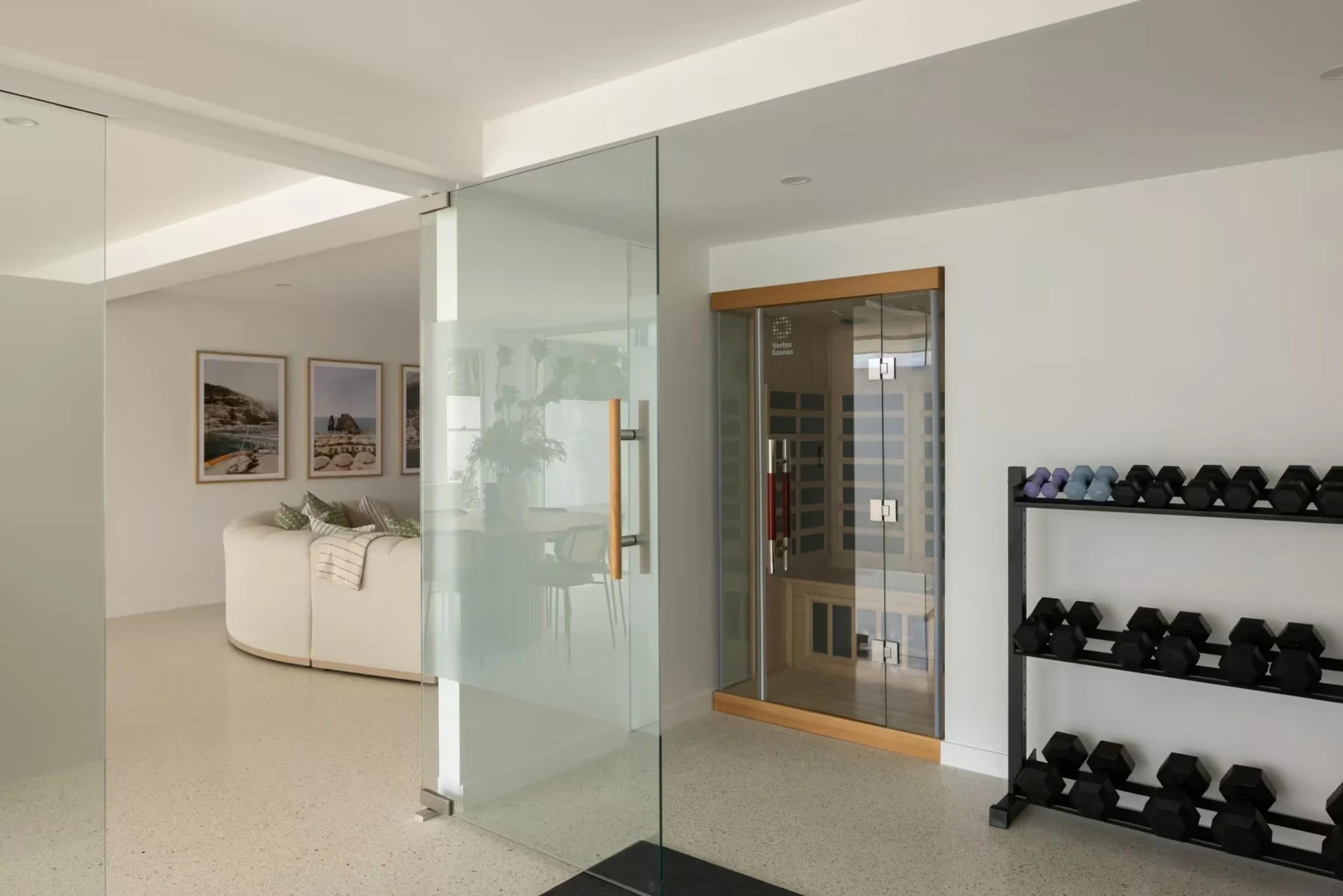 Home gym with sauna, weights and glass partition