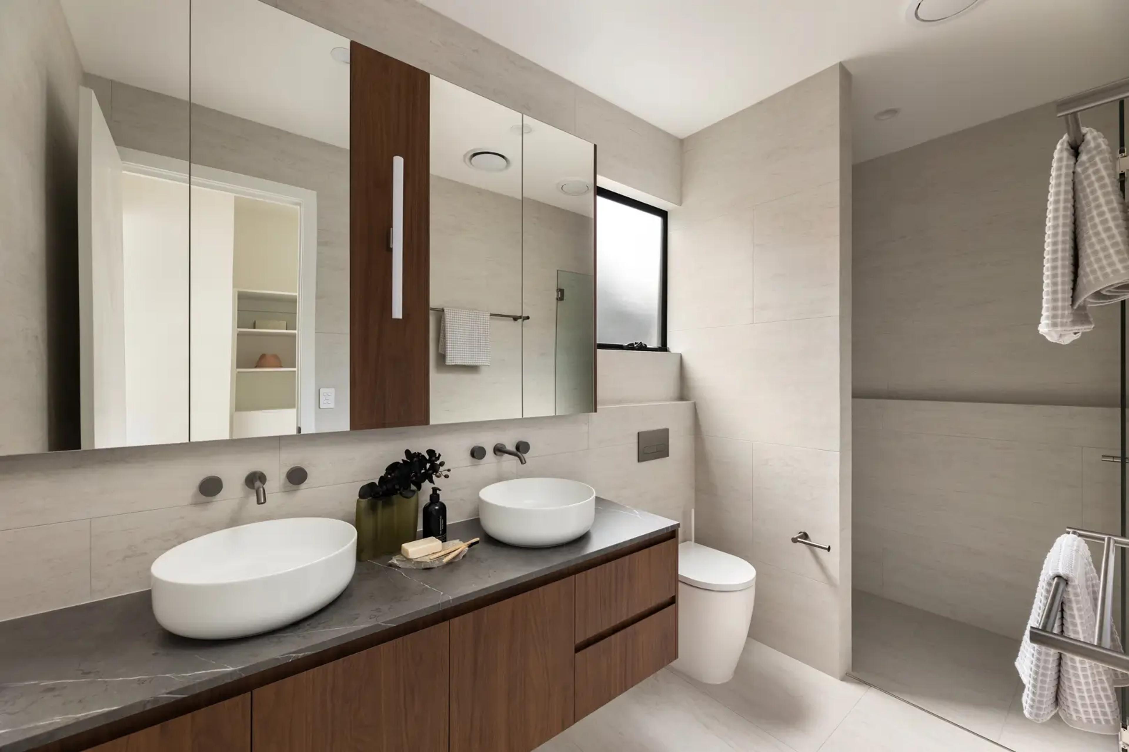 Bathroom with stone vanity and twin basins