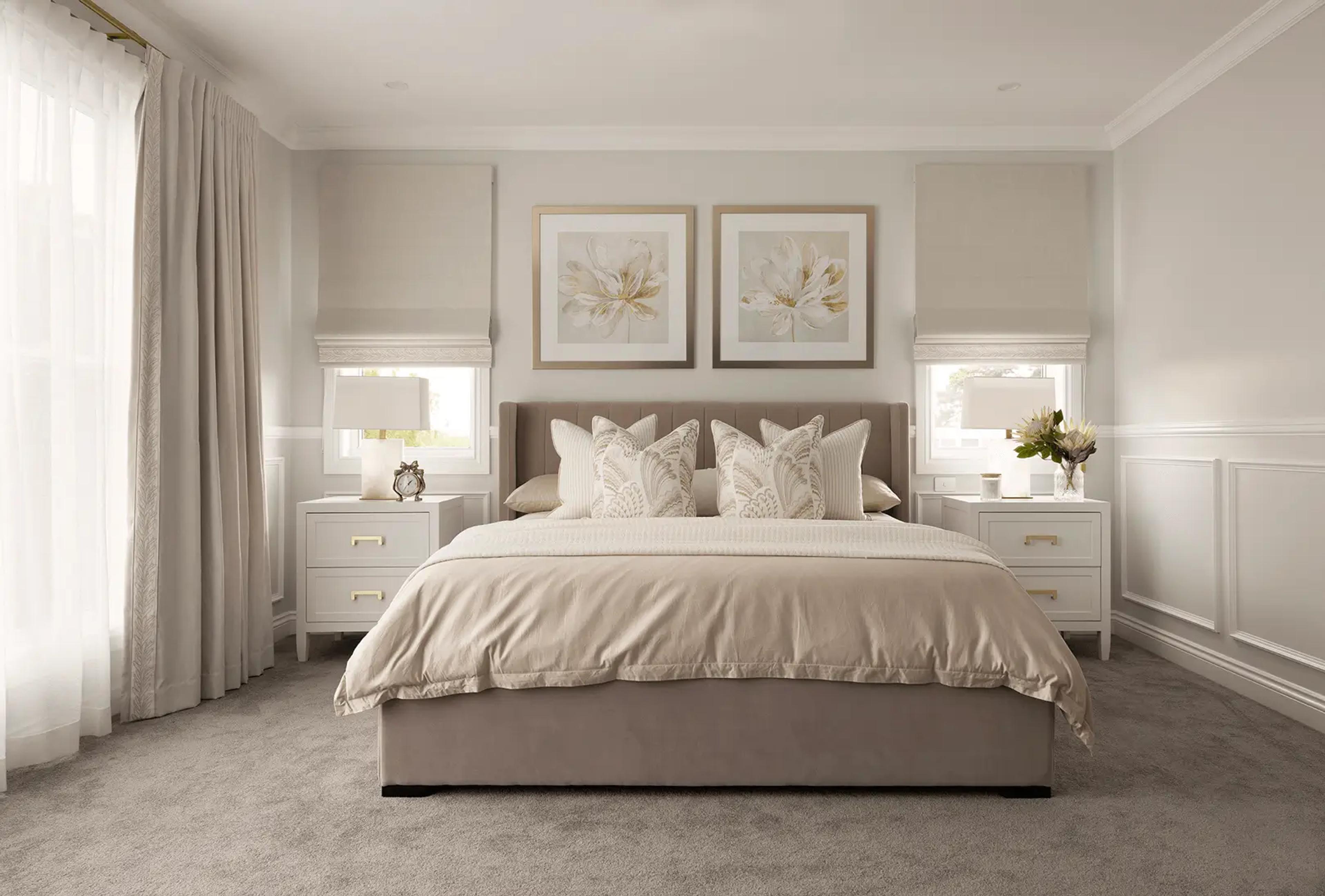 Main bedroom with upholstered bedhead and framed prints