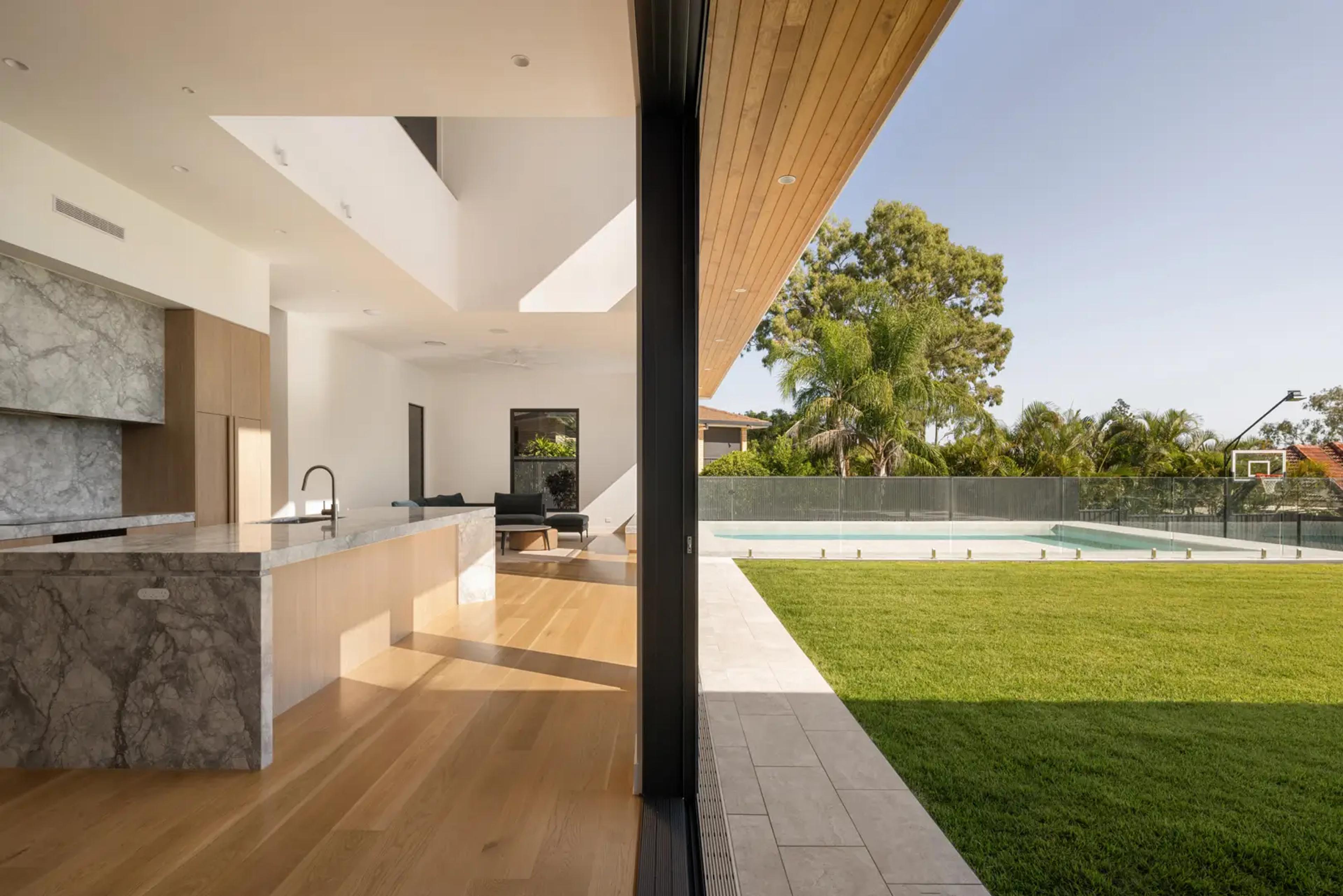 Kitchen opening to covered patio, pool and lawn