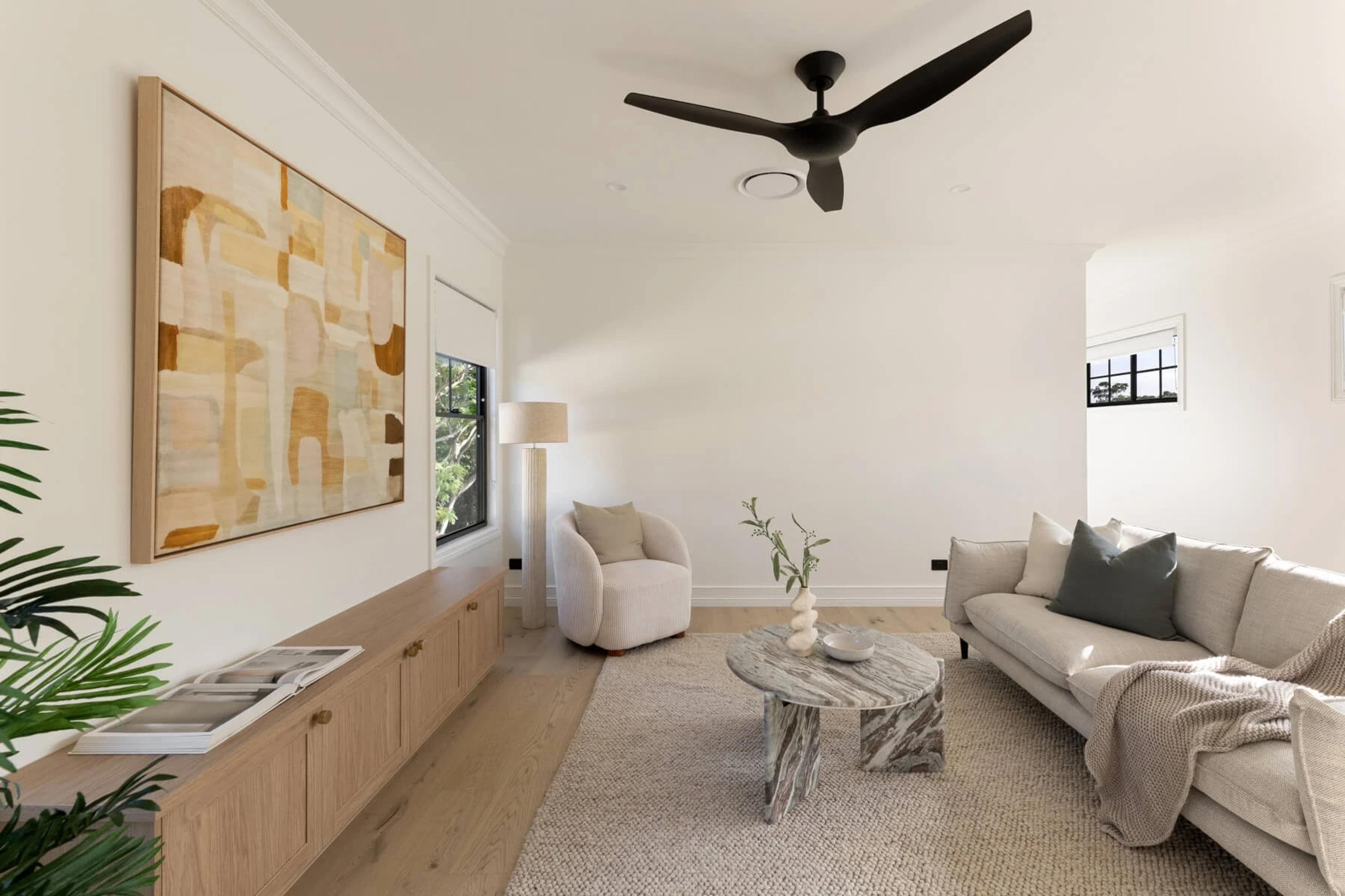Lounge with pale sofa, marble coffee table and artwork