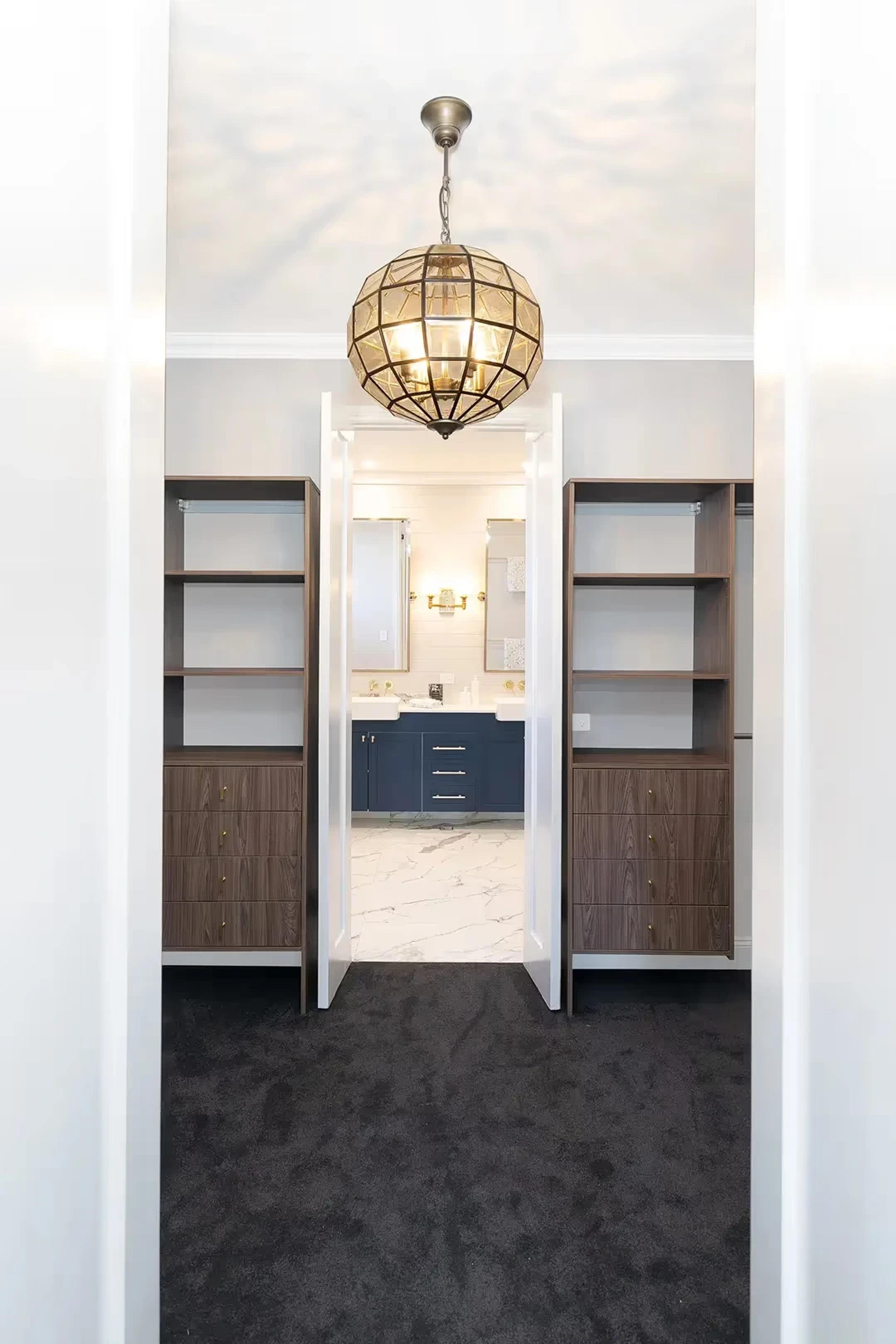 Walk in wardrobe leading through to an ensuite bathroom