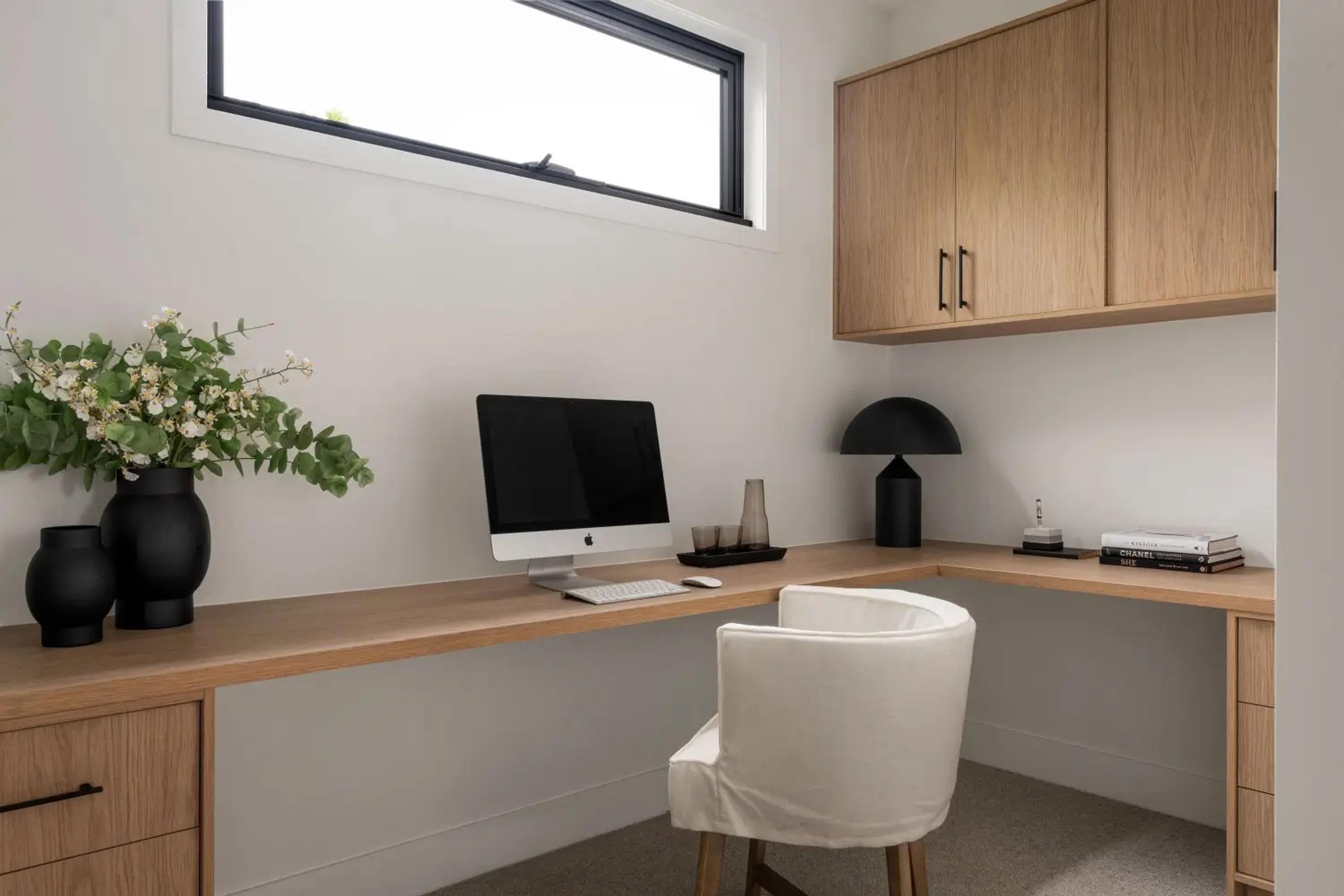Home office with floating timber desk and window
