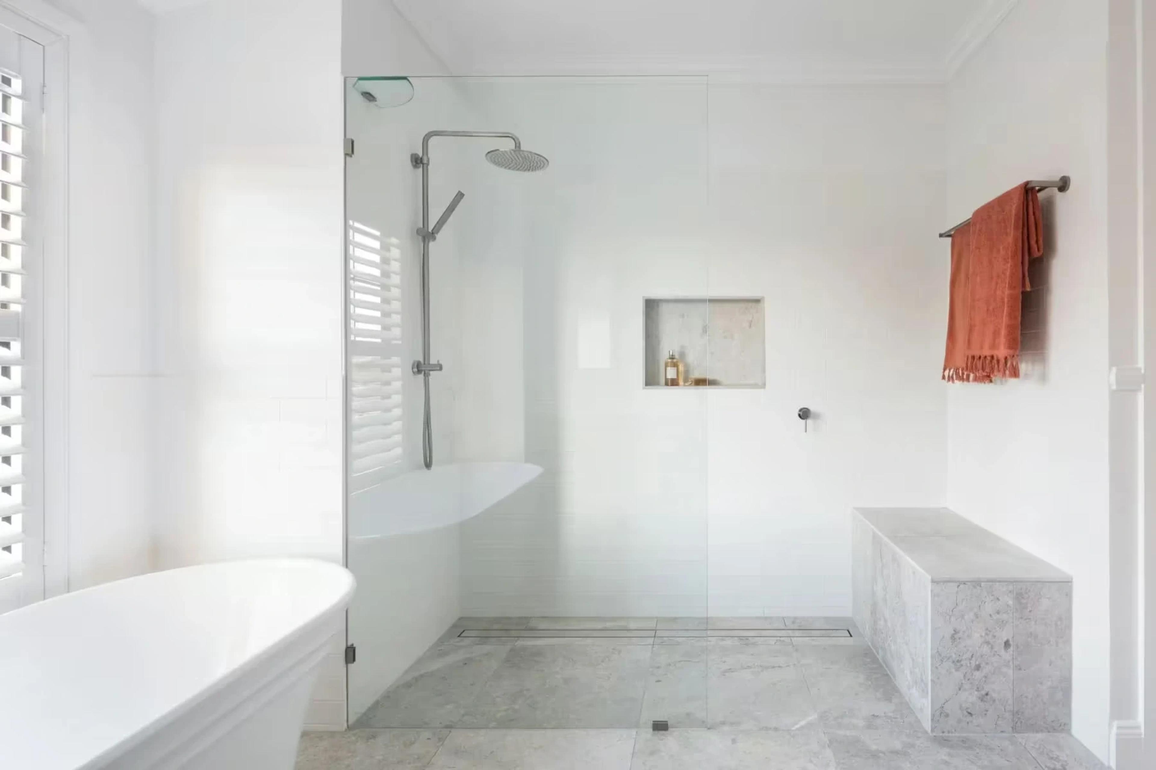 White bathroom with freestanding bath and walk-in shower