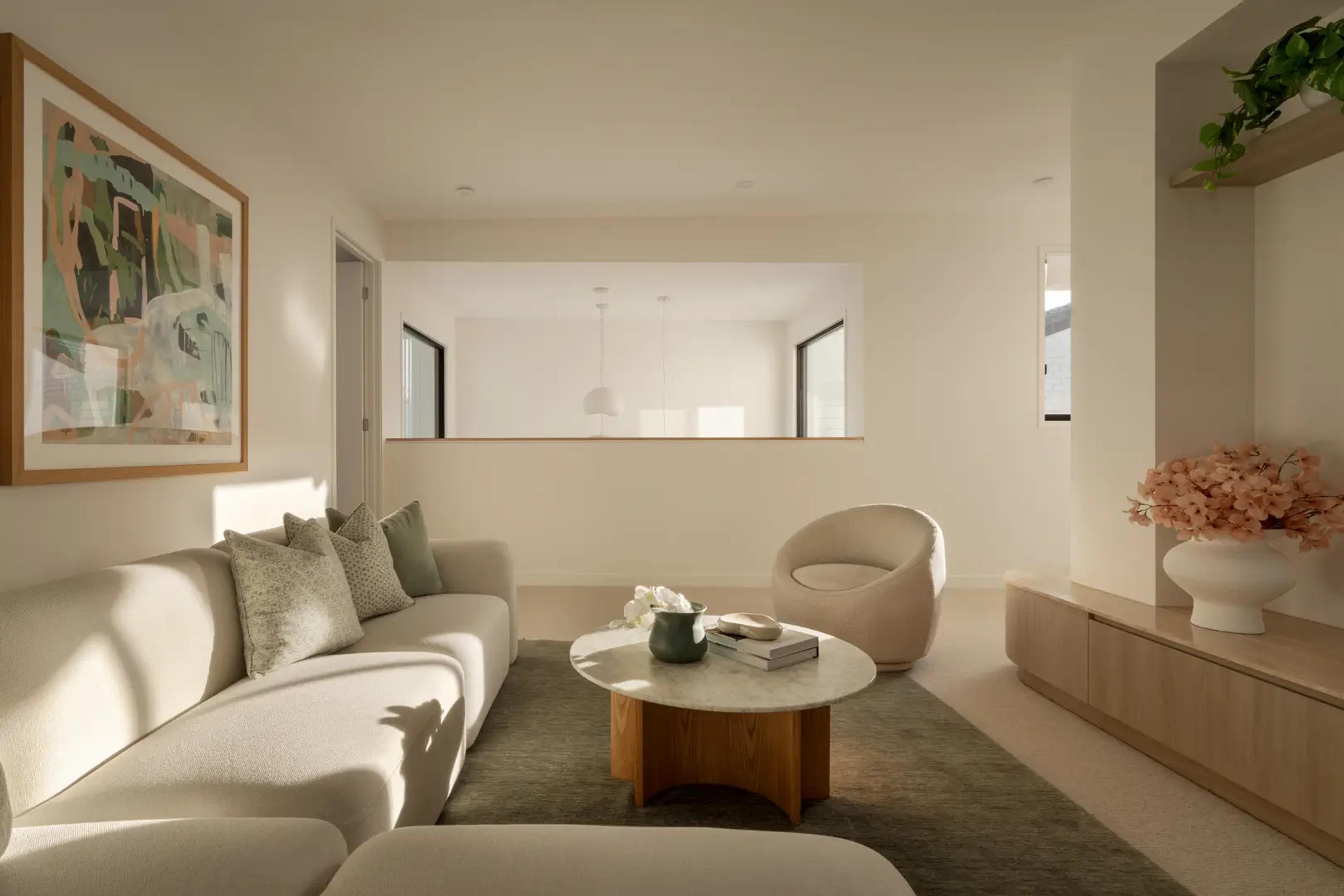 Lounge with curved sofa, round coffee table and artwork