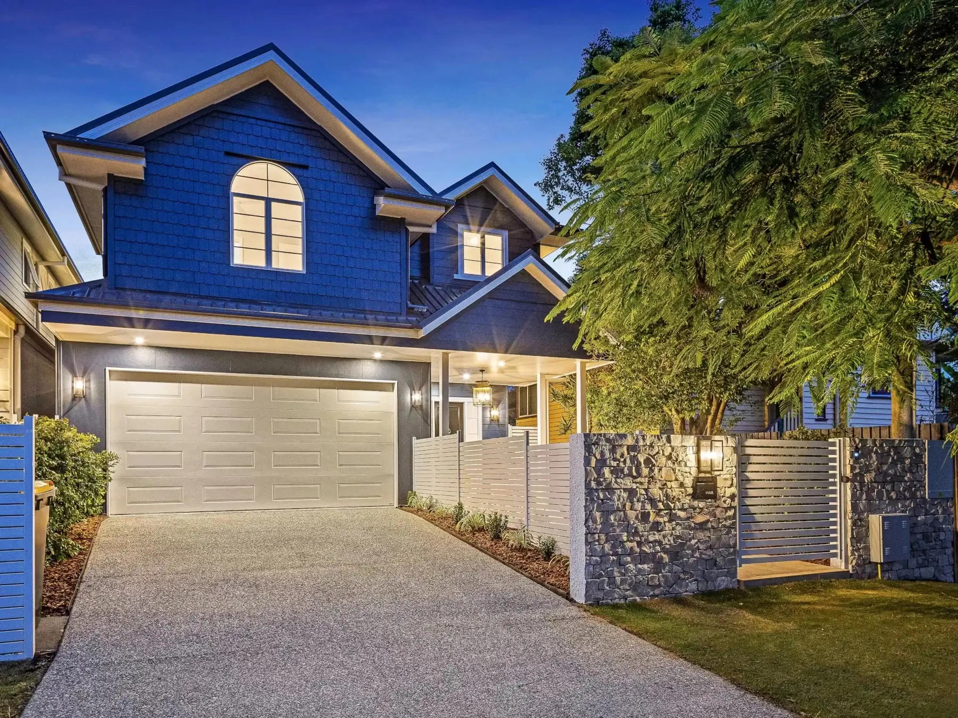 Two storey home front facade with double garage and driveway
