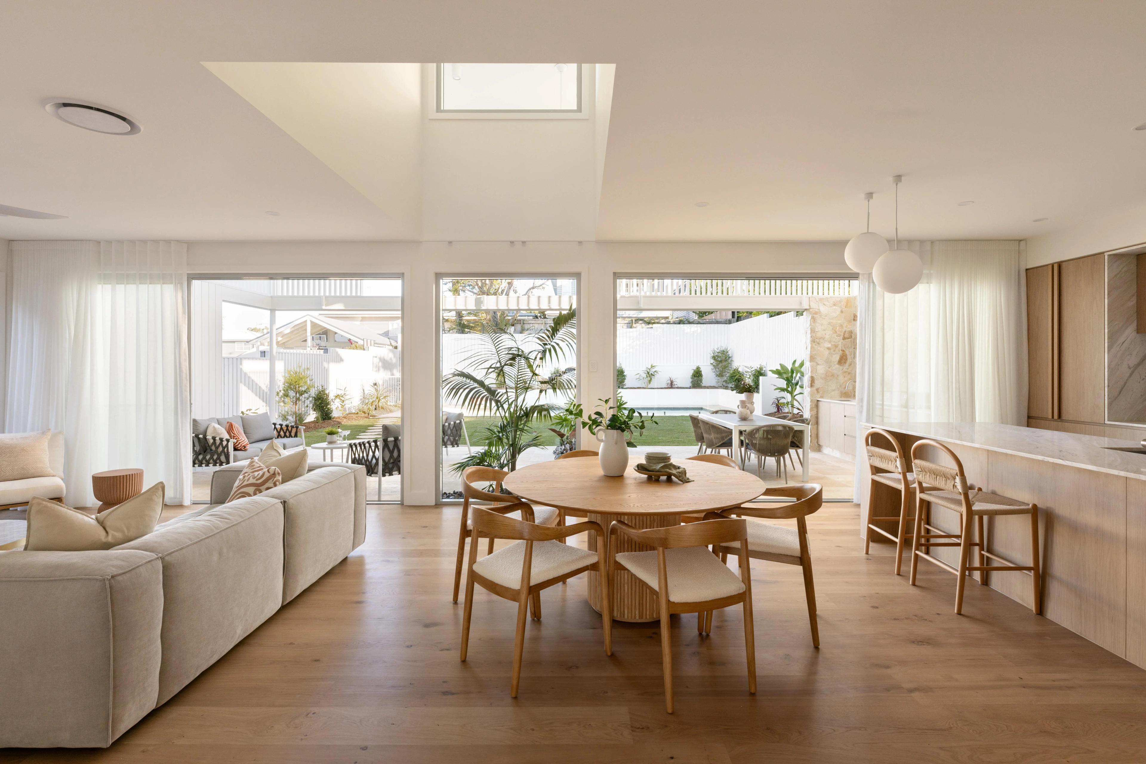 Open plan living and dining space opening to backyard pool