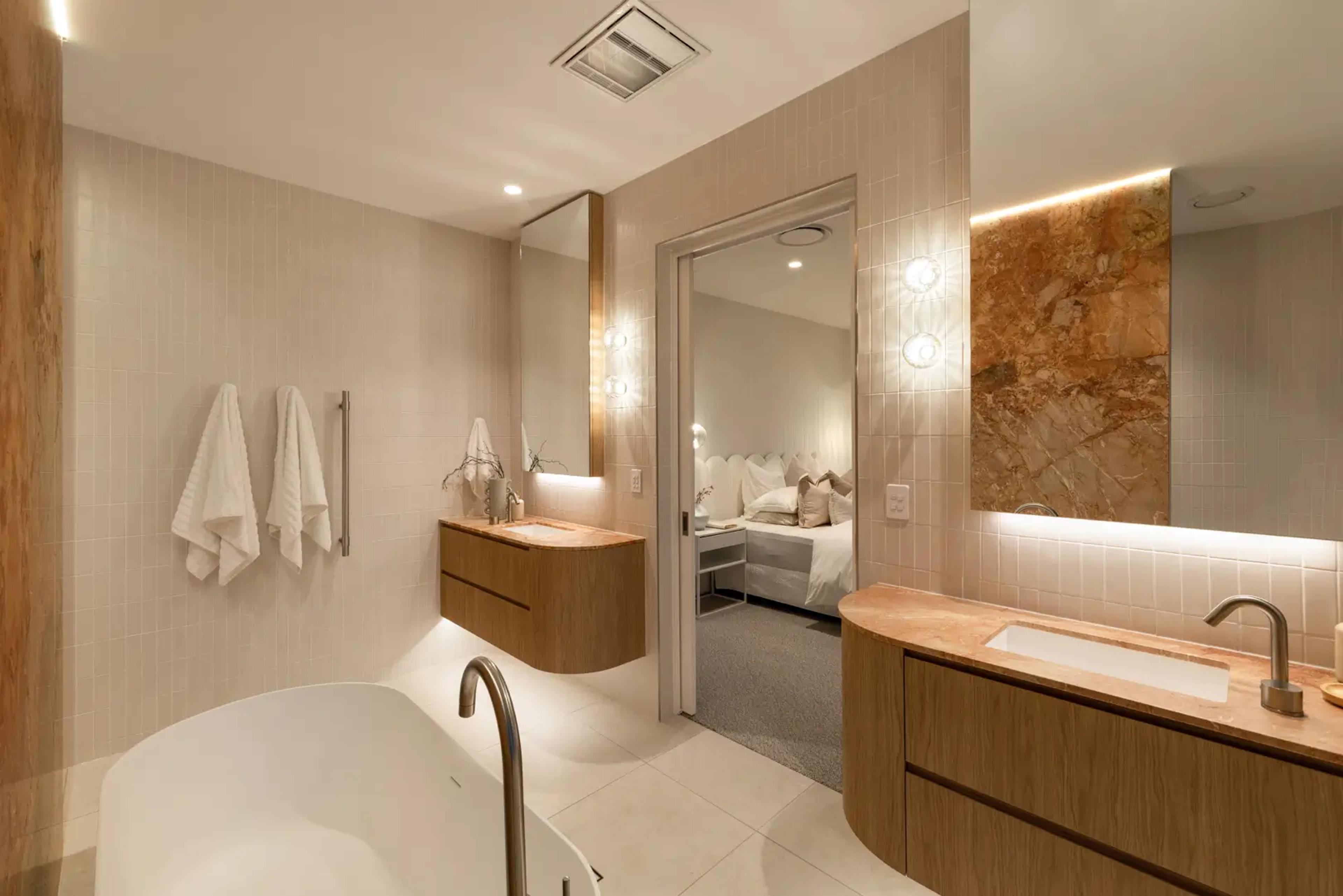 Ensuite with freestanding bath and bedroom beyond