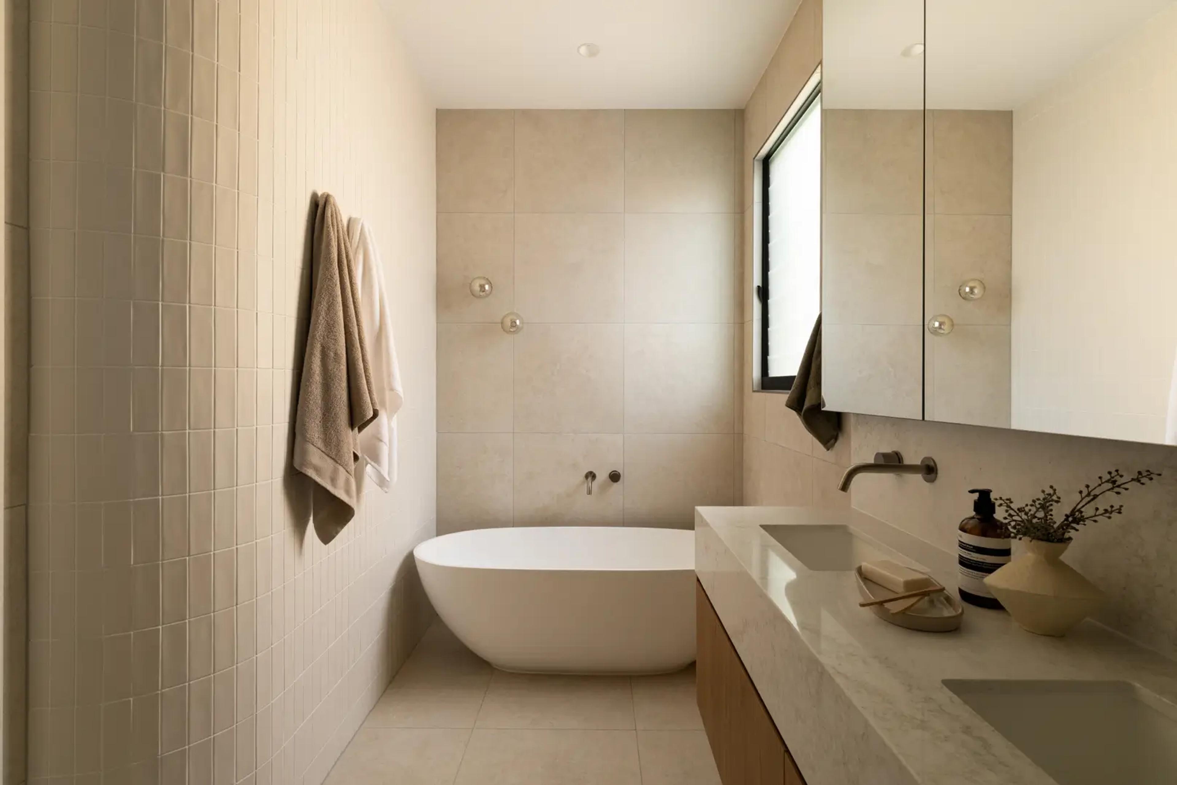 Bathroom with freestanding bath and tiled walls