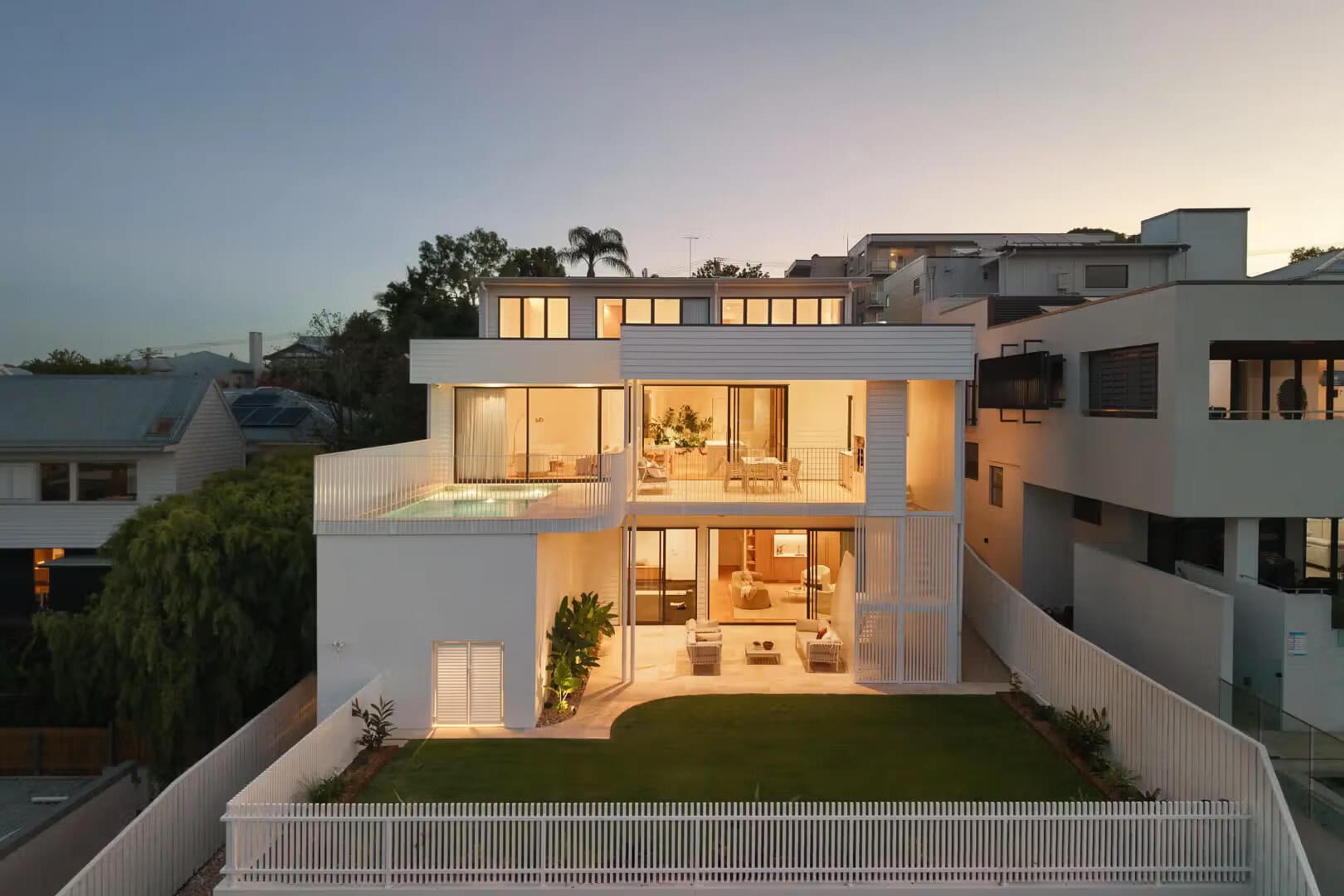 Home stepping down a sloping block with pool terrace and rear garden, Prelude in Bulimba, by Invilla Architecture.