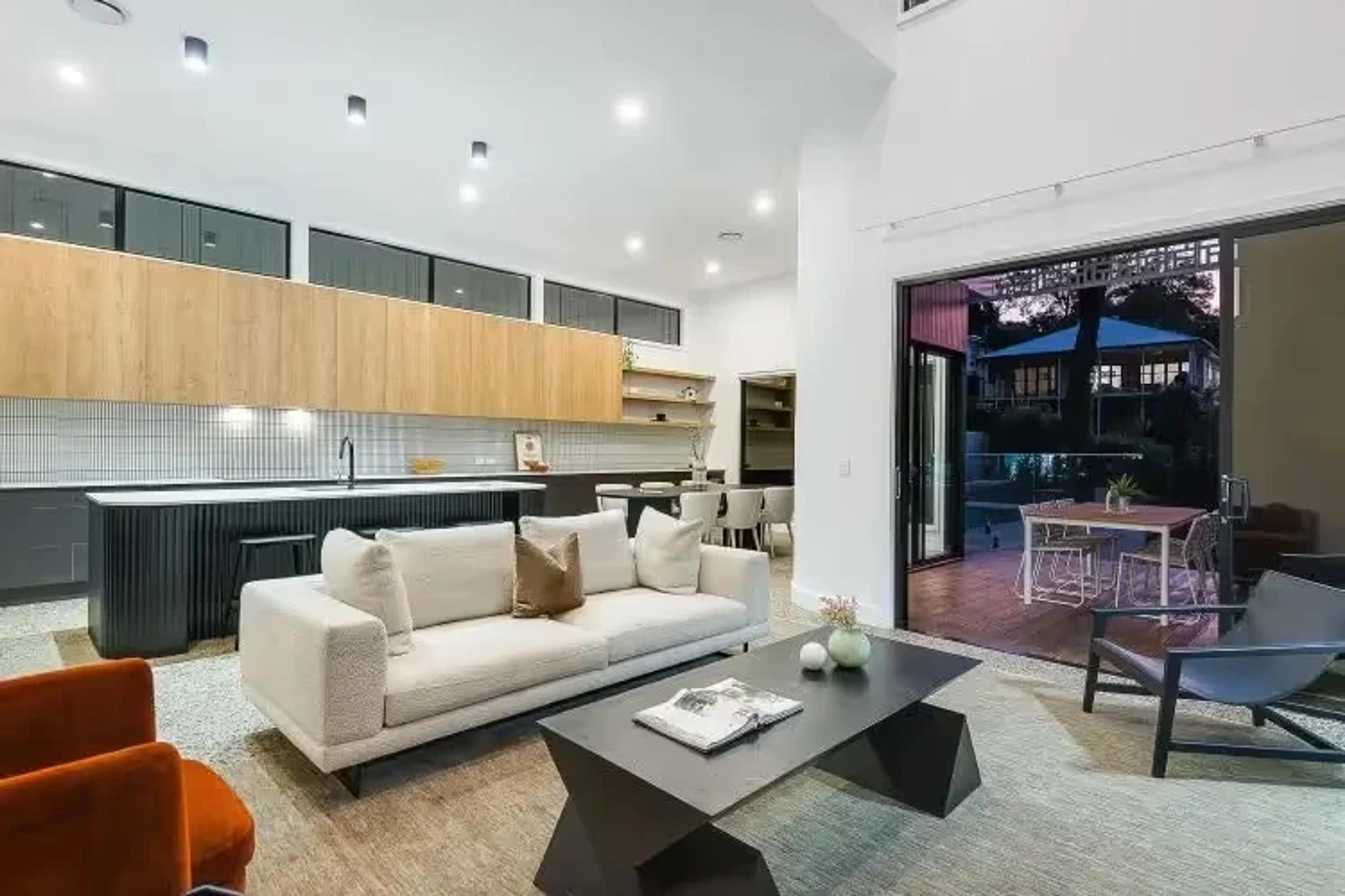 Open plan living room and kitchen opening to outdoor terrace