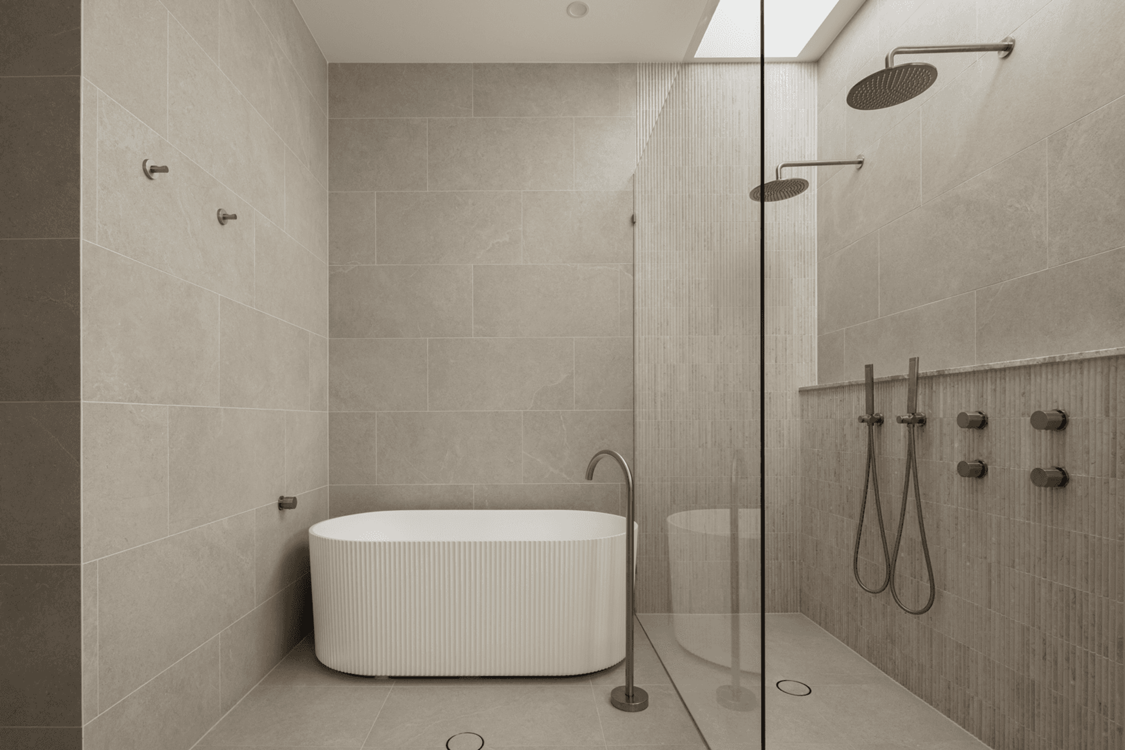 Bathroom with freestanding bath and dual shower