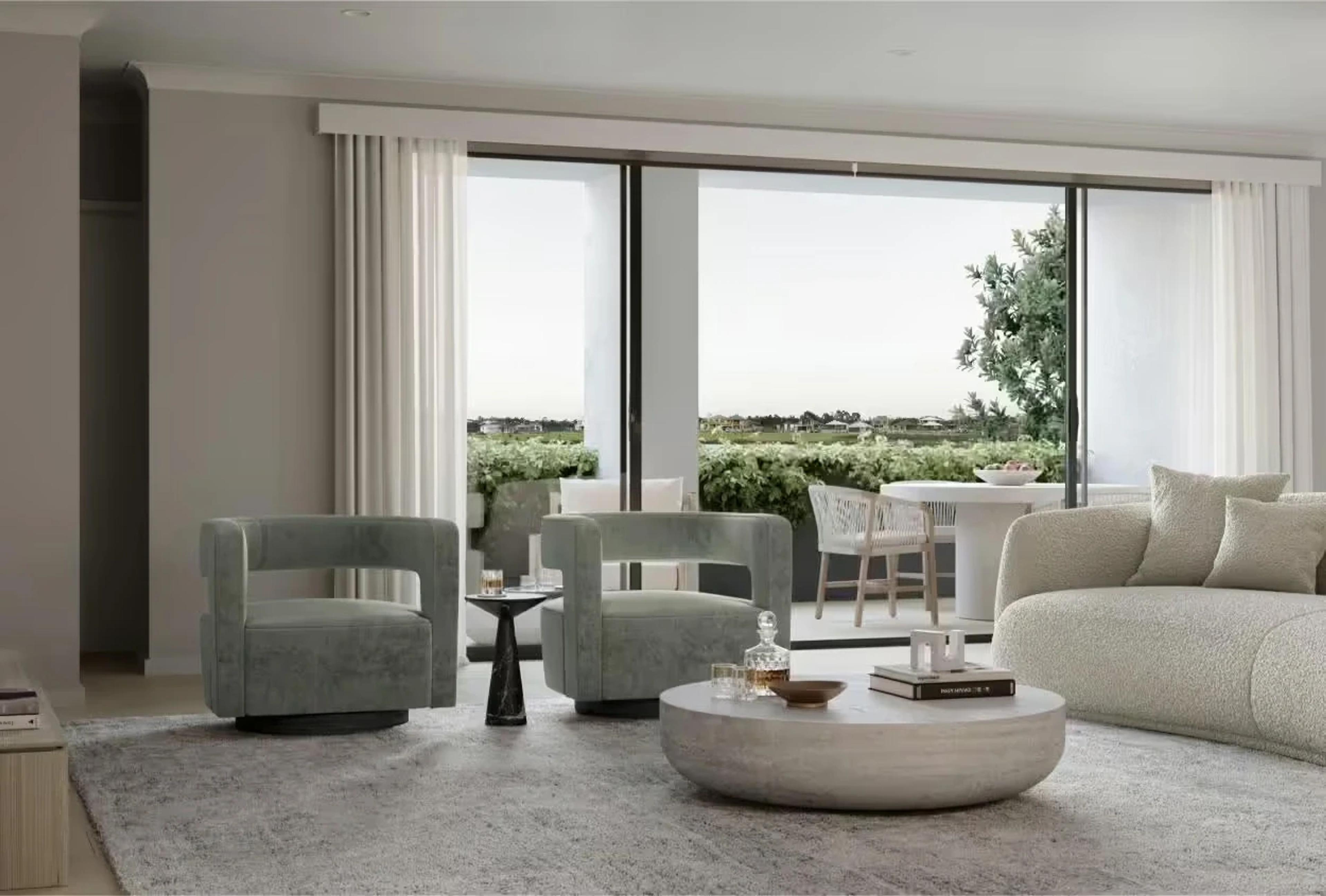 Living room with grey armchairs and sliding doors to terrace