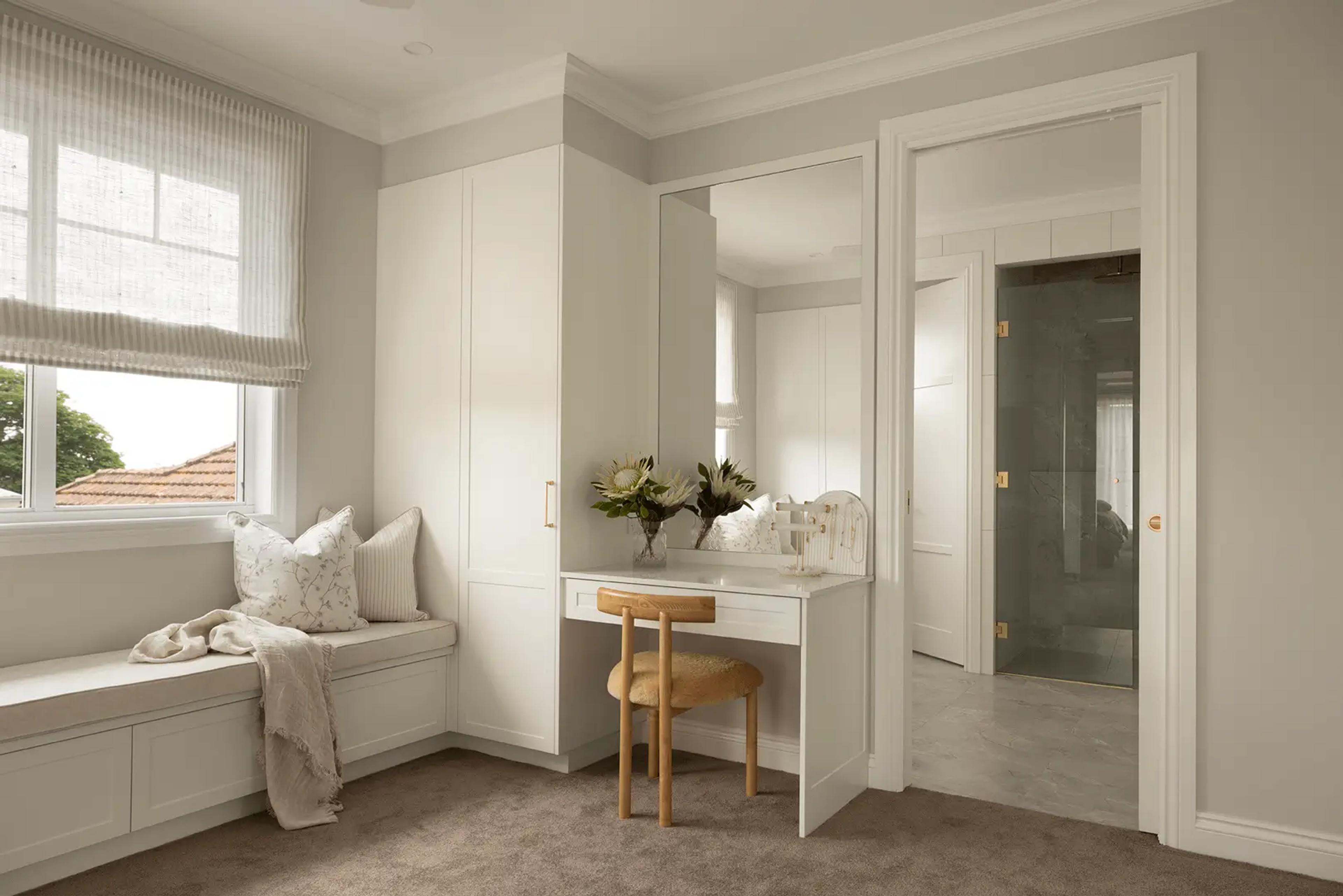 Dressing room with vanity, window seat and ensuite beyond