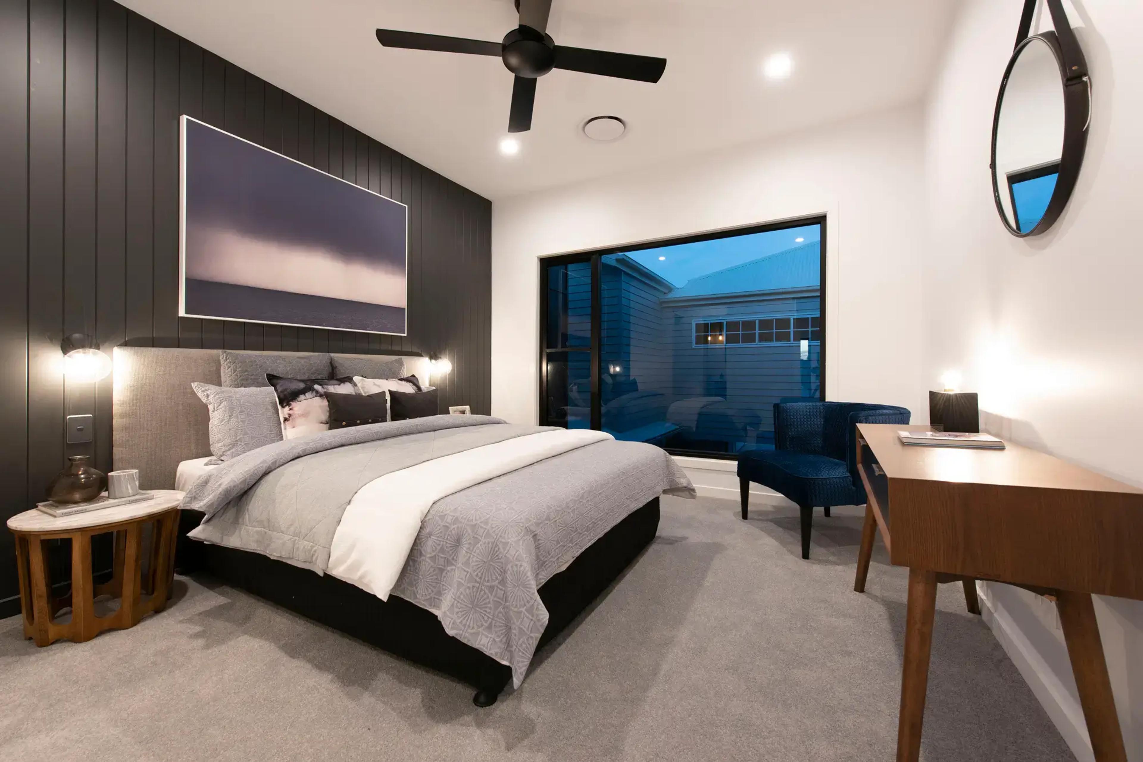 Bedroom with dark feature wall and picture window
