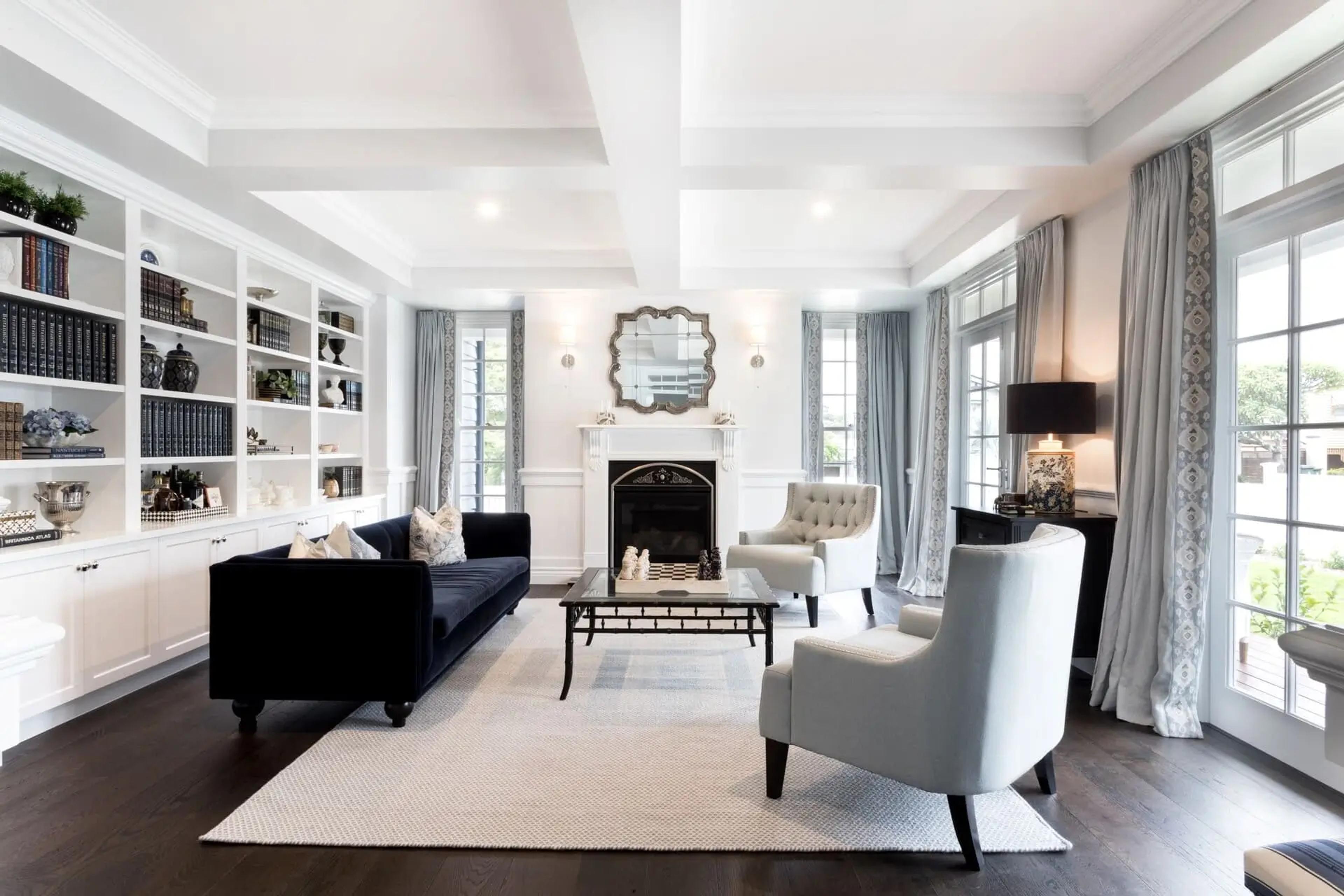 Formal living room with black sofa and fireplace