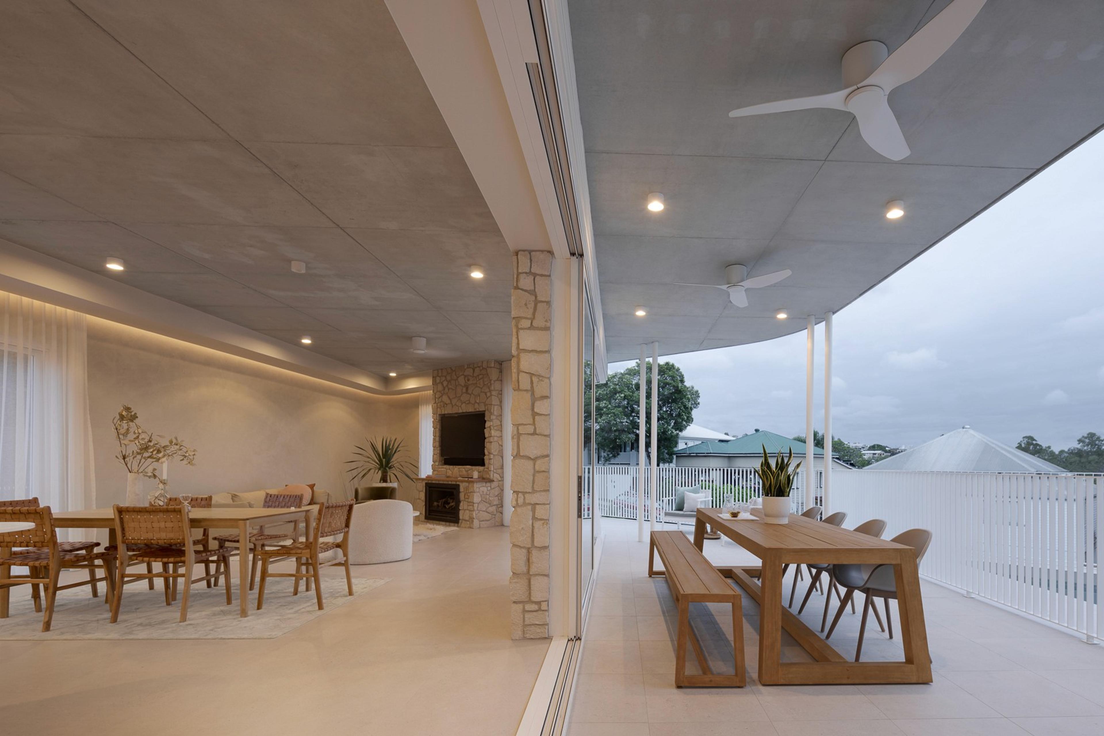 Covered outdoor dining and lounge area at dusk