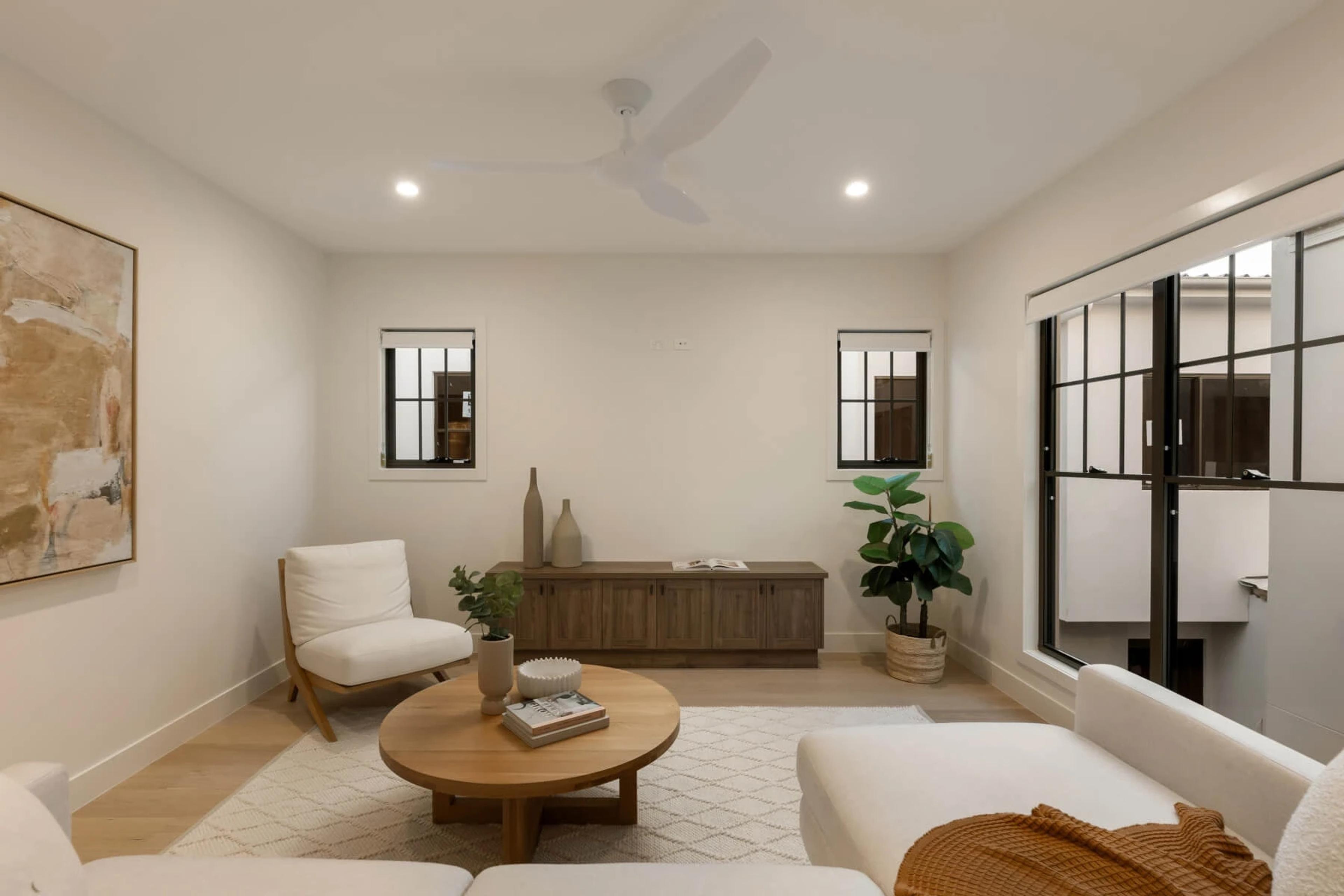 Sitting room with armchairs, round table and internal windows
