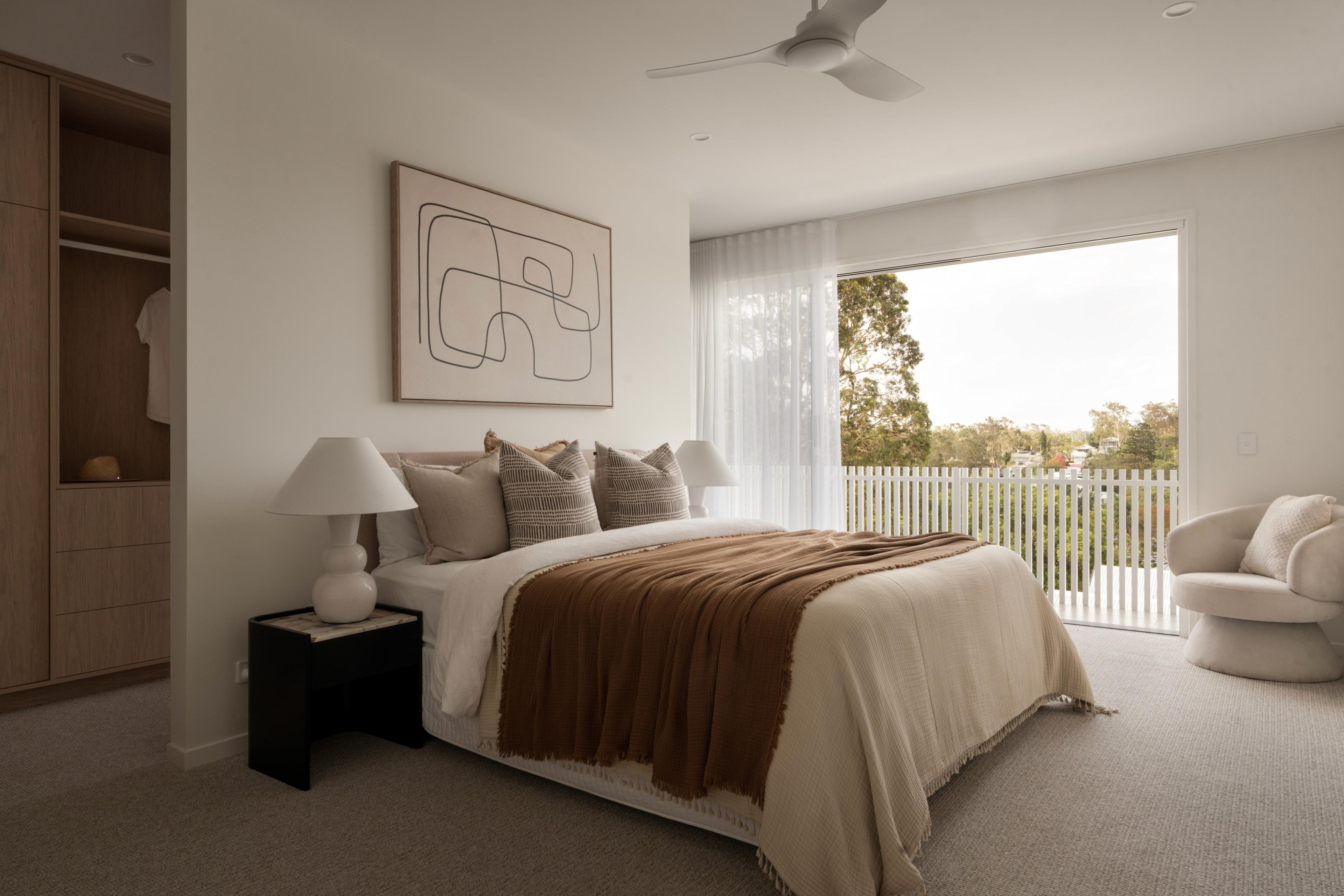 Bedroom with balcony access and treetop views