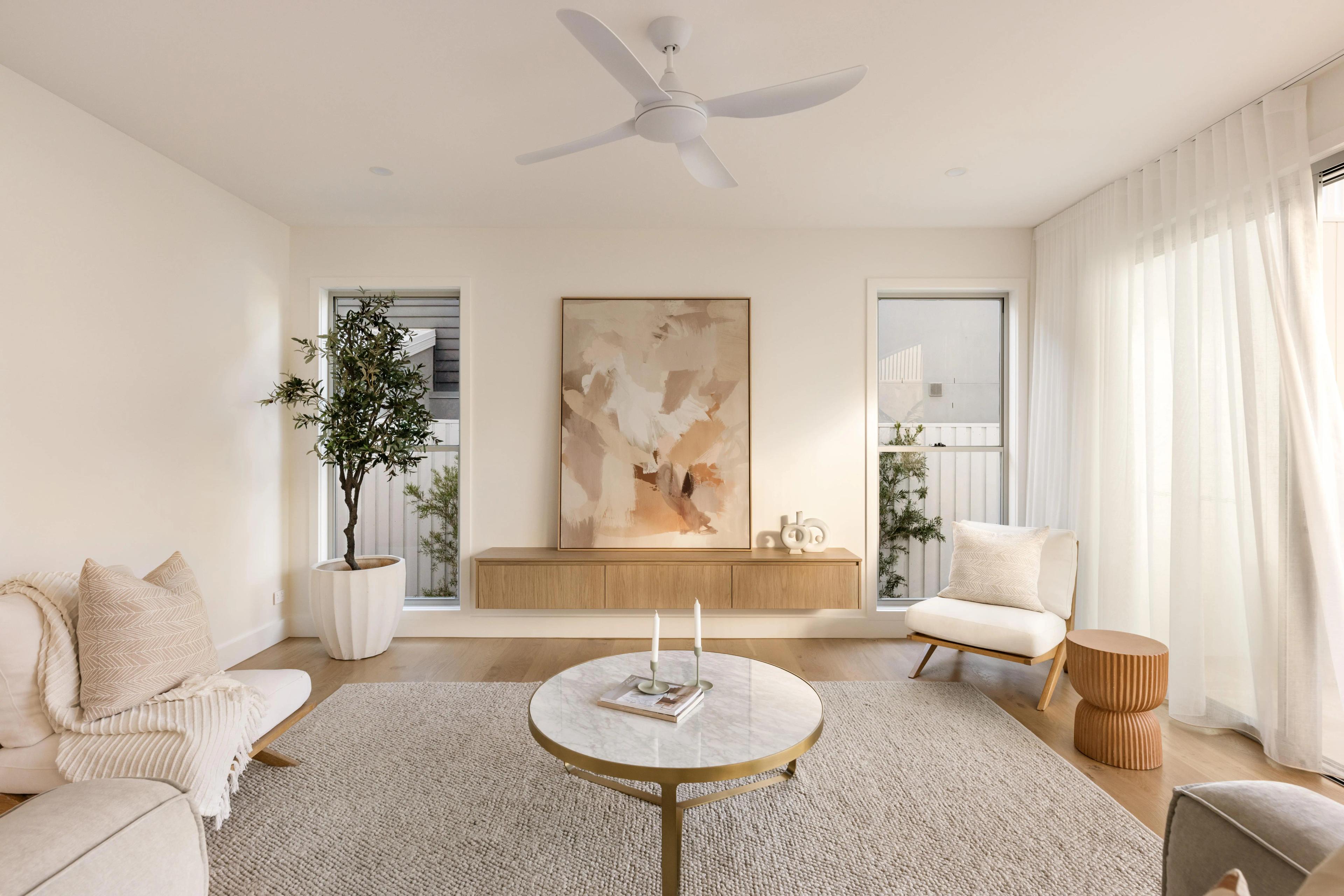 Bright living room with neutral furnishings and framed artwork