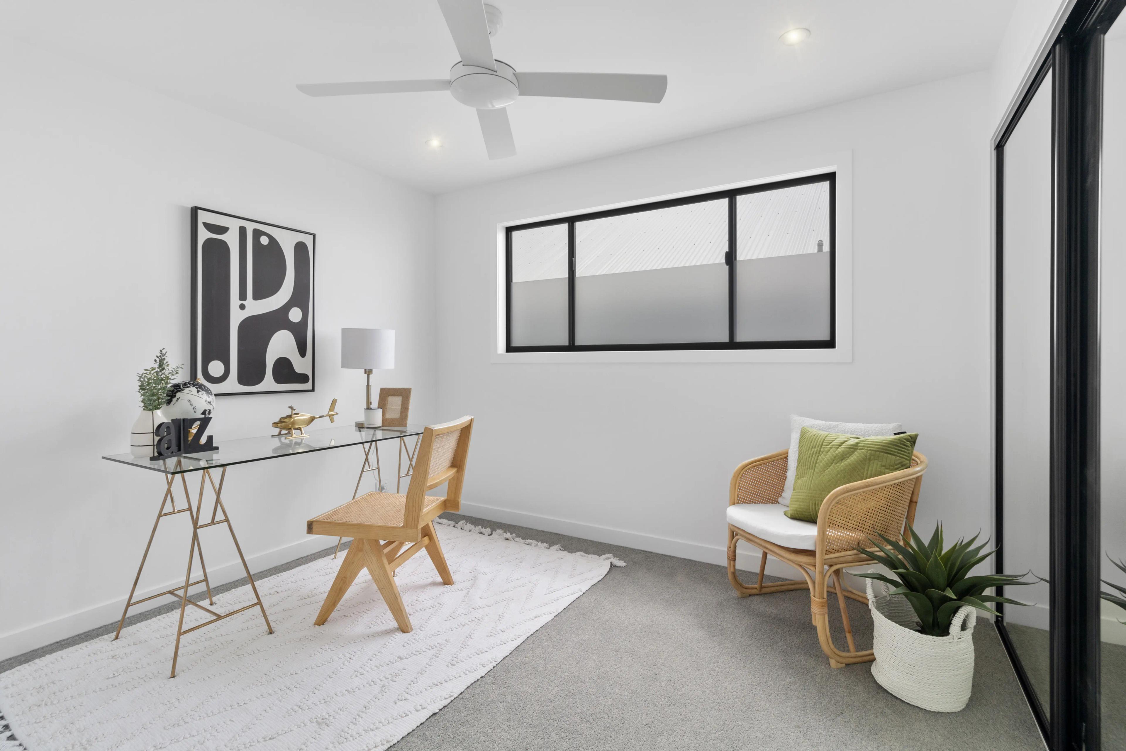 Home office with glass desk, chair and frosted window