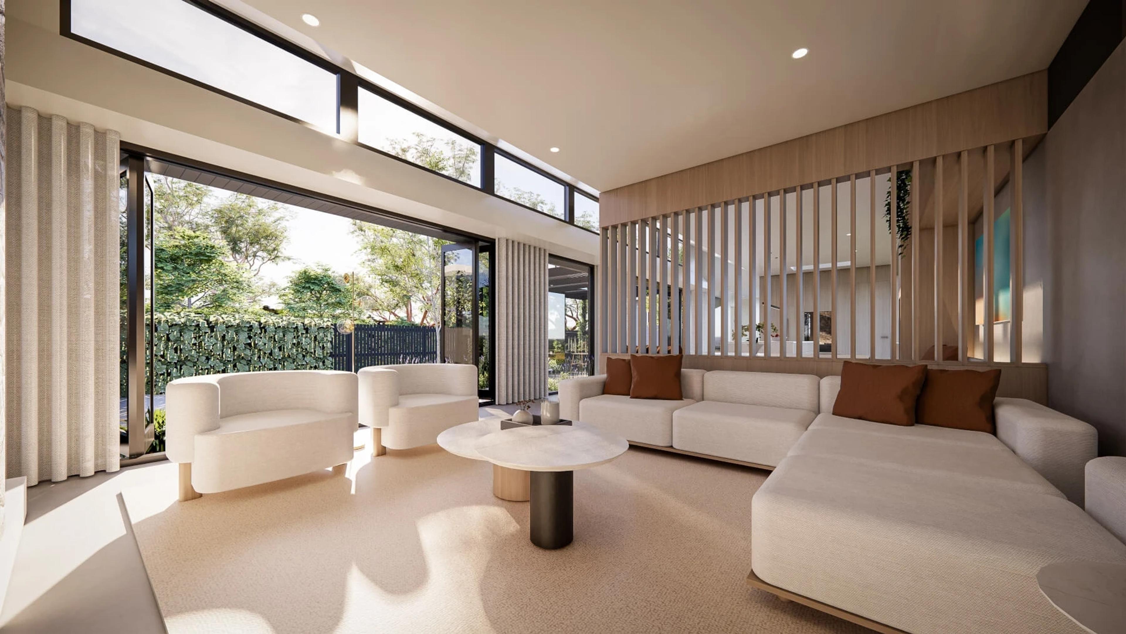 Living room with pale sofas opening to garden through sliding doors