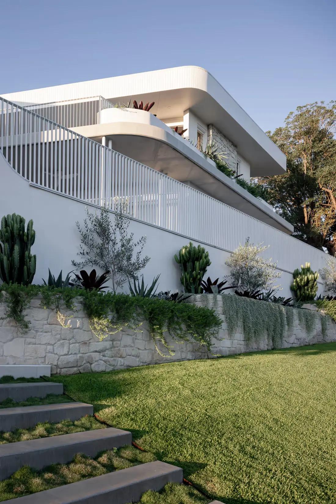 Striking curved architectural facade integrated with subtropical landscaping
