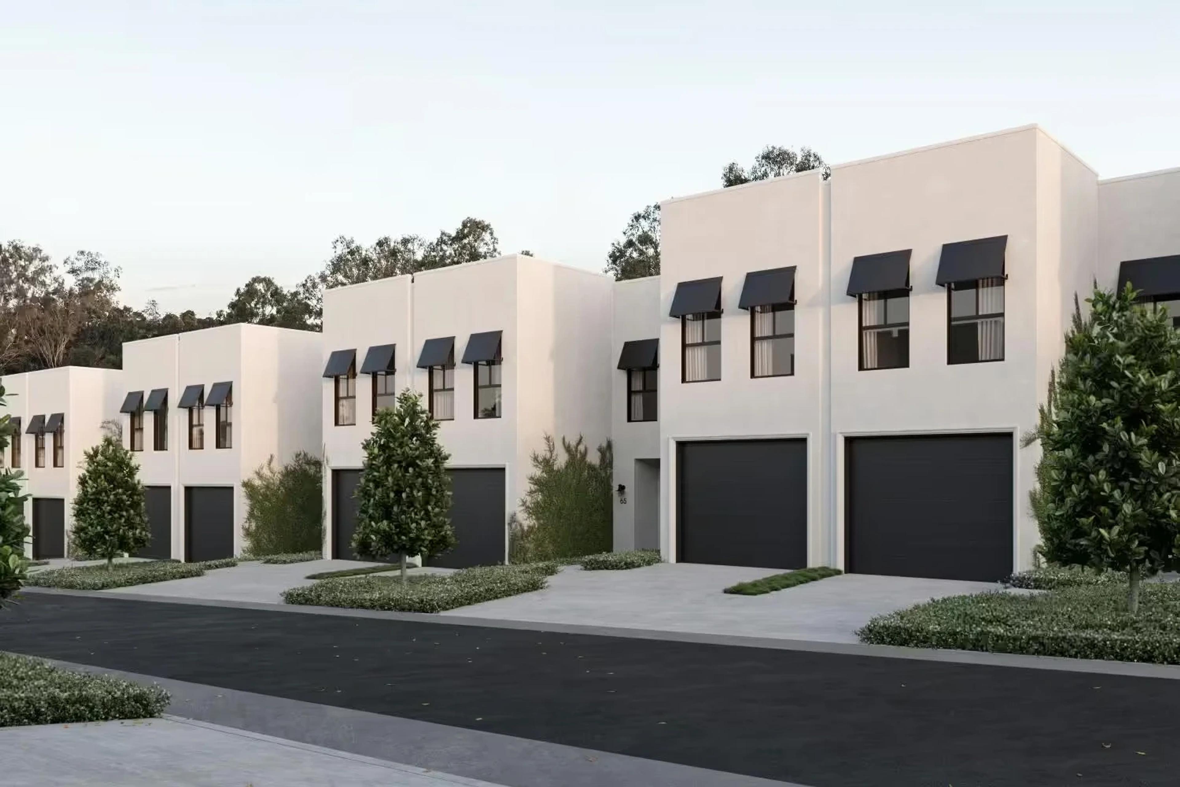 Cream townhouses with window awnings and single garages