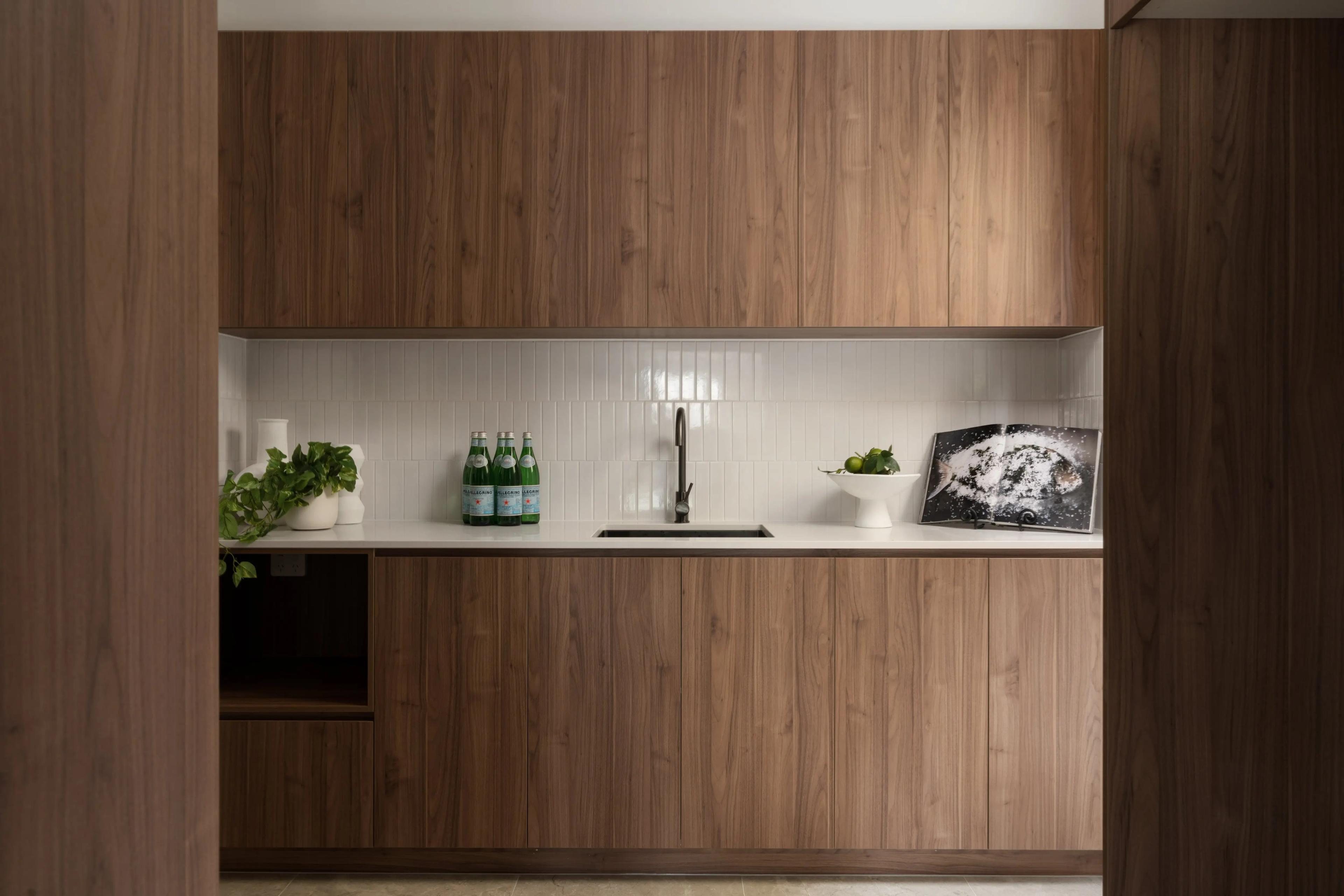 Butler pantry with timber cabinetry and tiled splashback