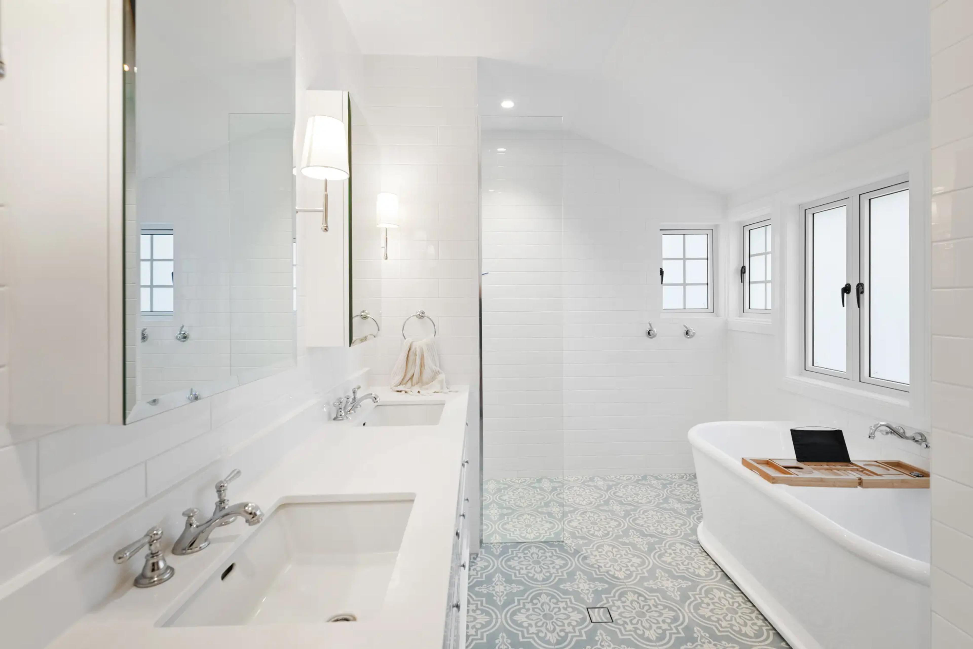 Bathroom with freestanding bath and patterned floor tiles