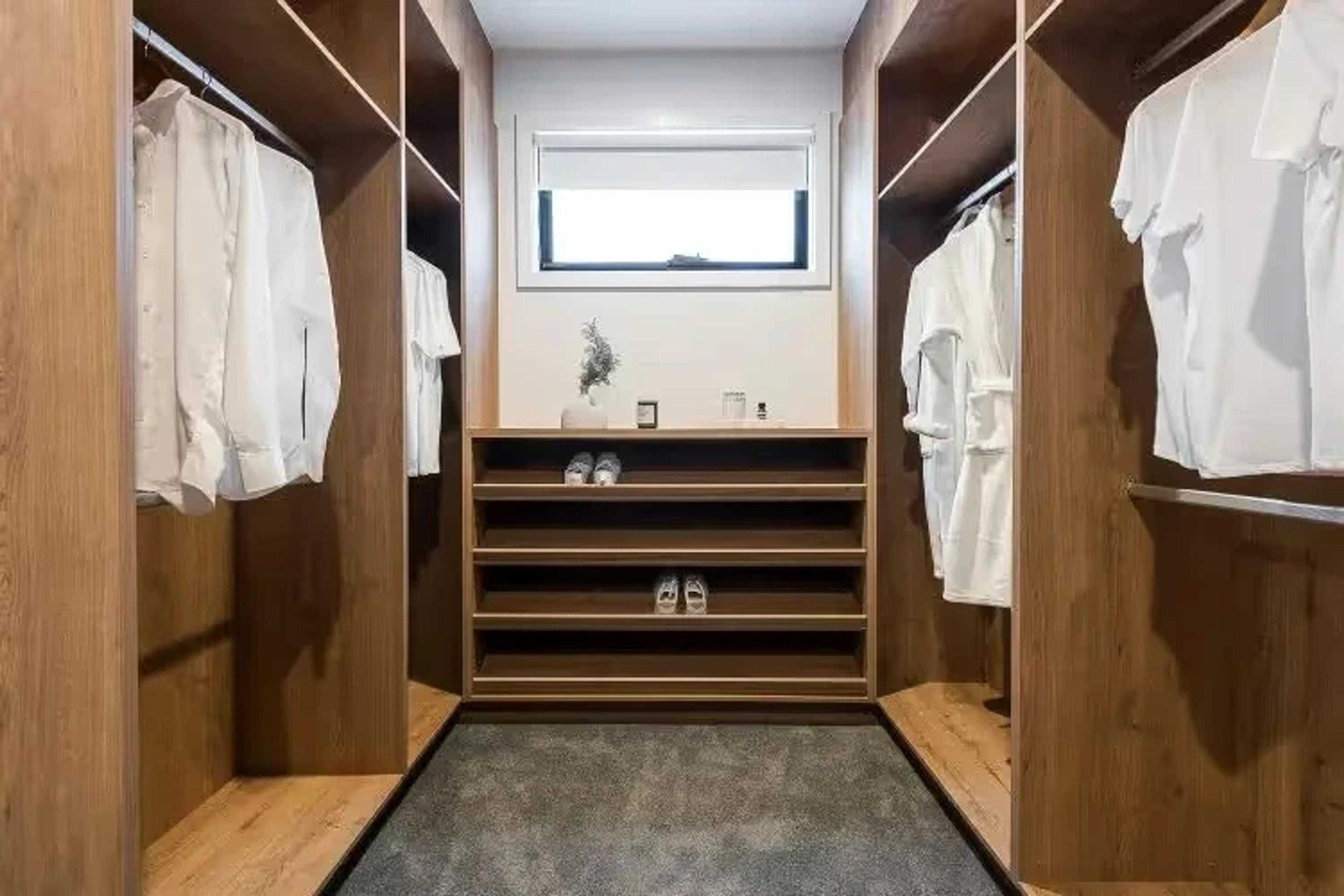 Walk in wardrobe with timber shelving and hanging space