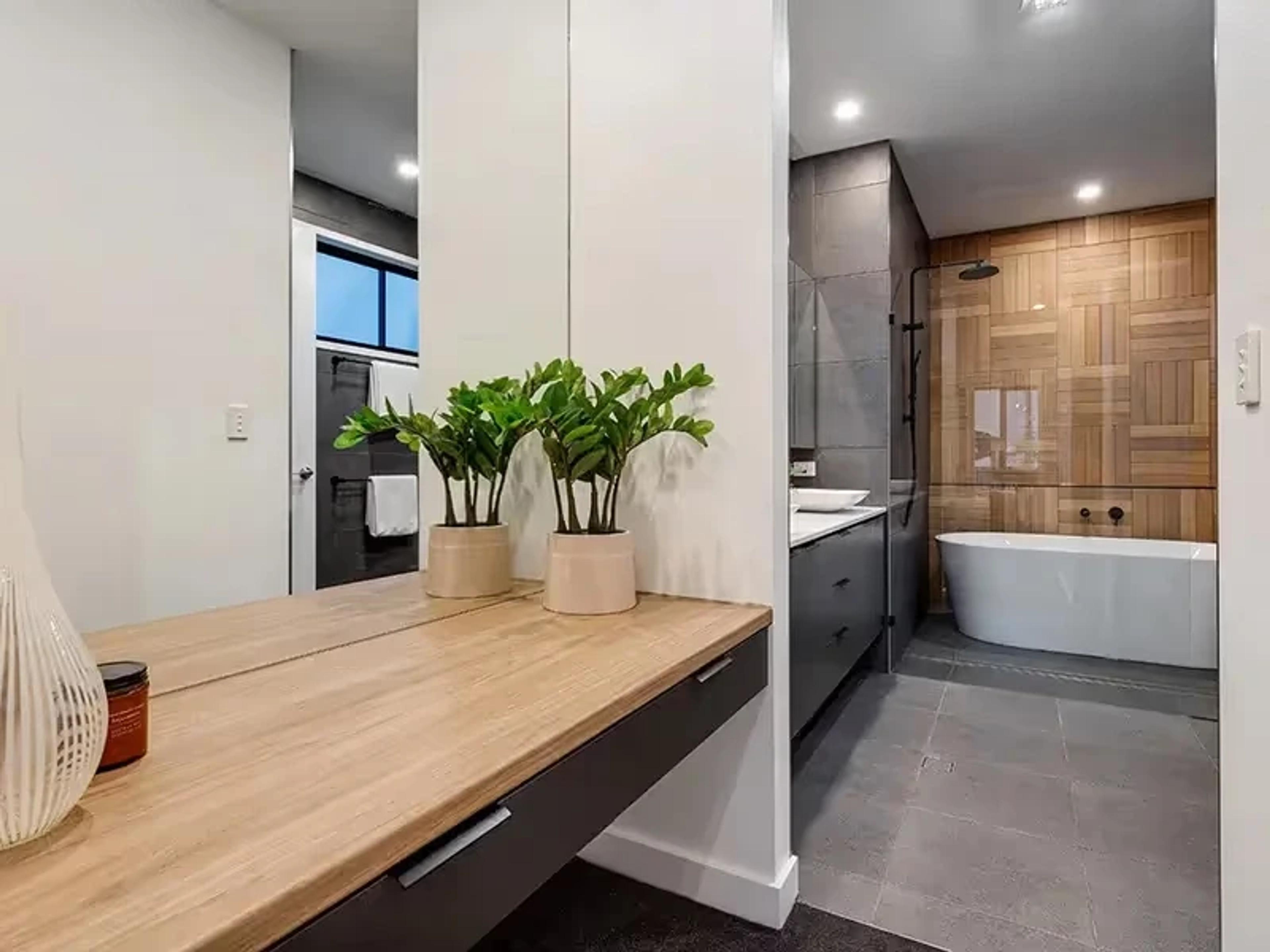 Bathroom with timber vanity, freestanding bath and shower