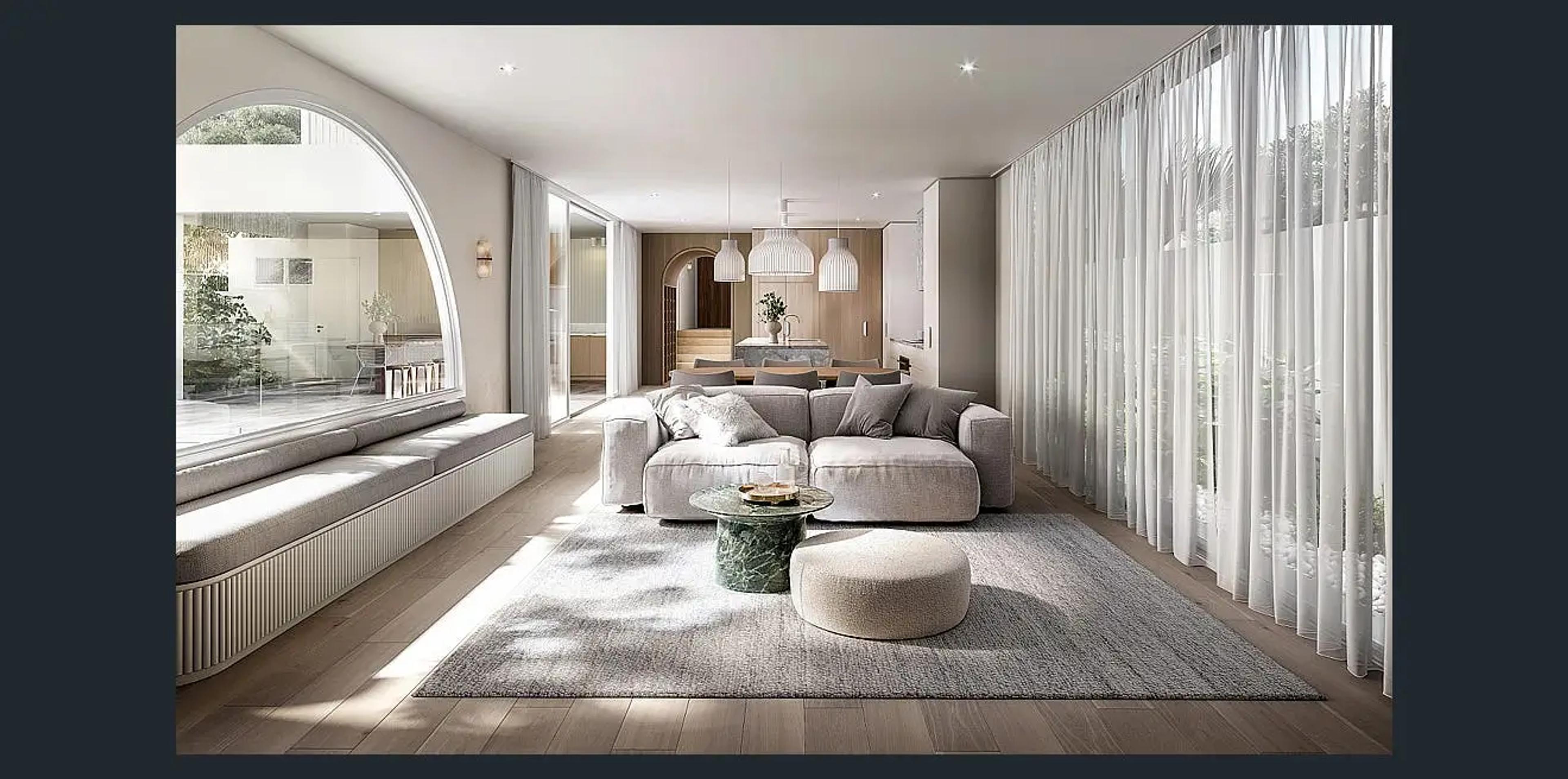 Open plan living room with sofa, sheer curtains and arched window seat