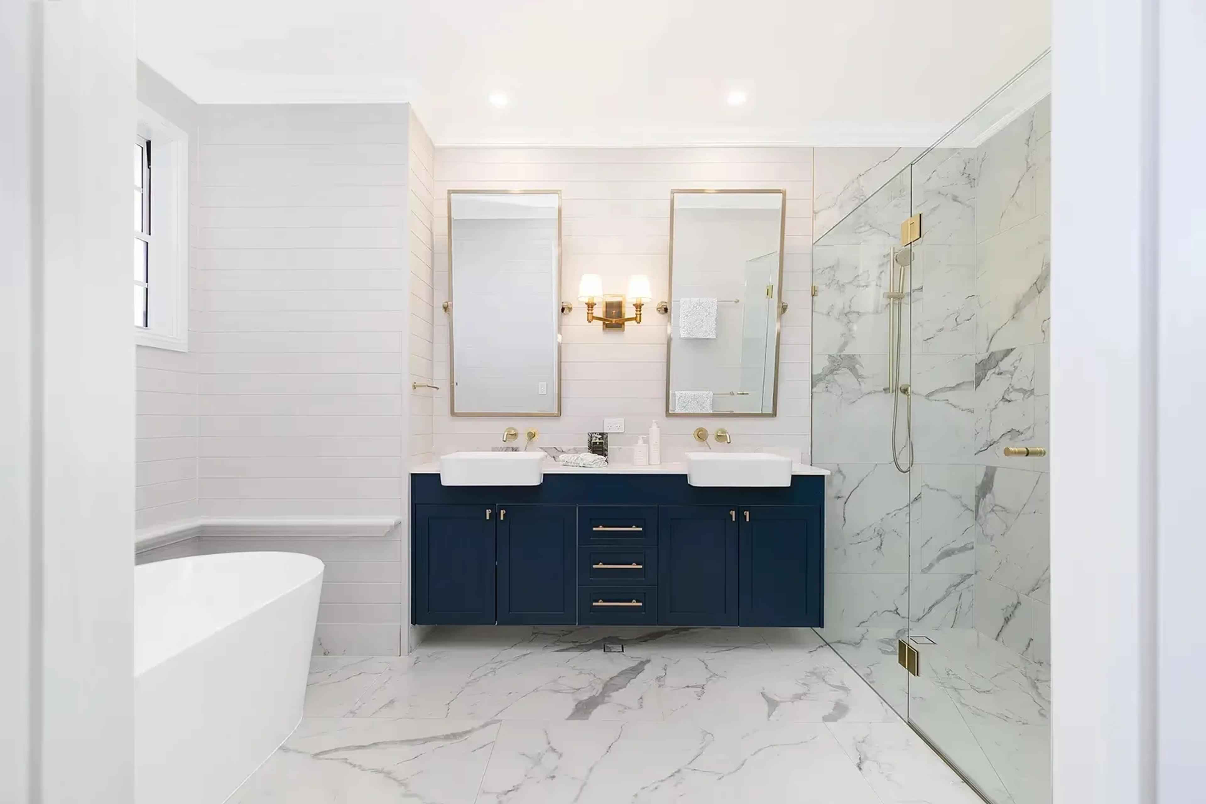 Ensuite with freestanding bath, navy vanity and marble shower