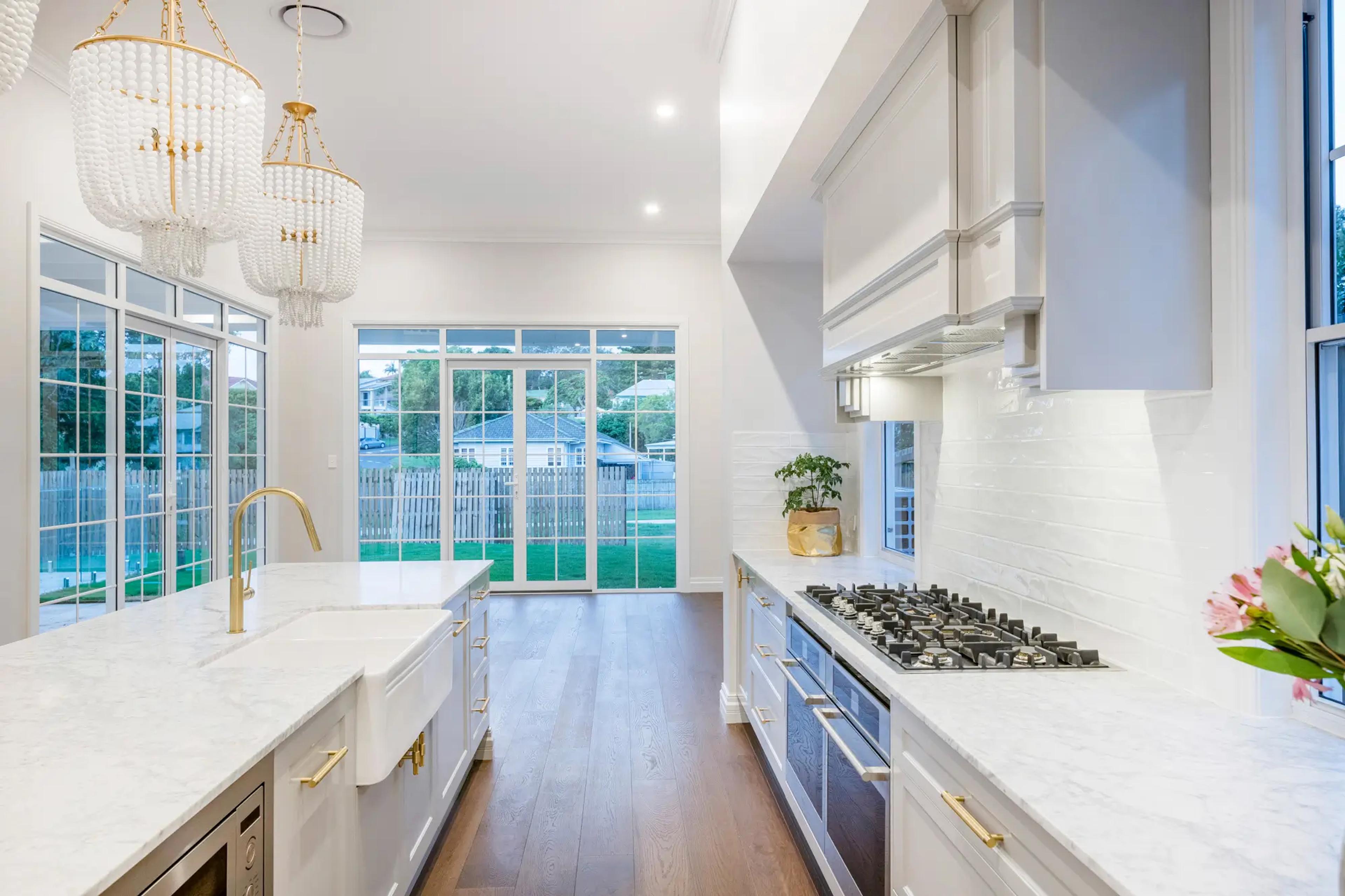 Kitchen with marble benchtops and garden views through windows