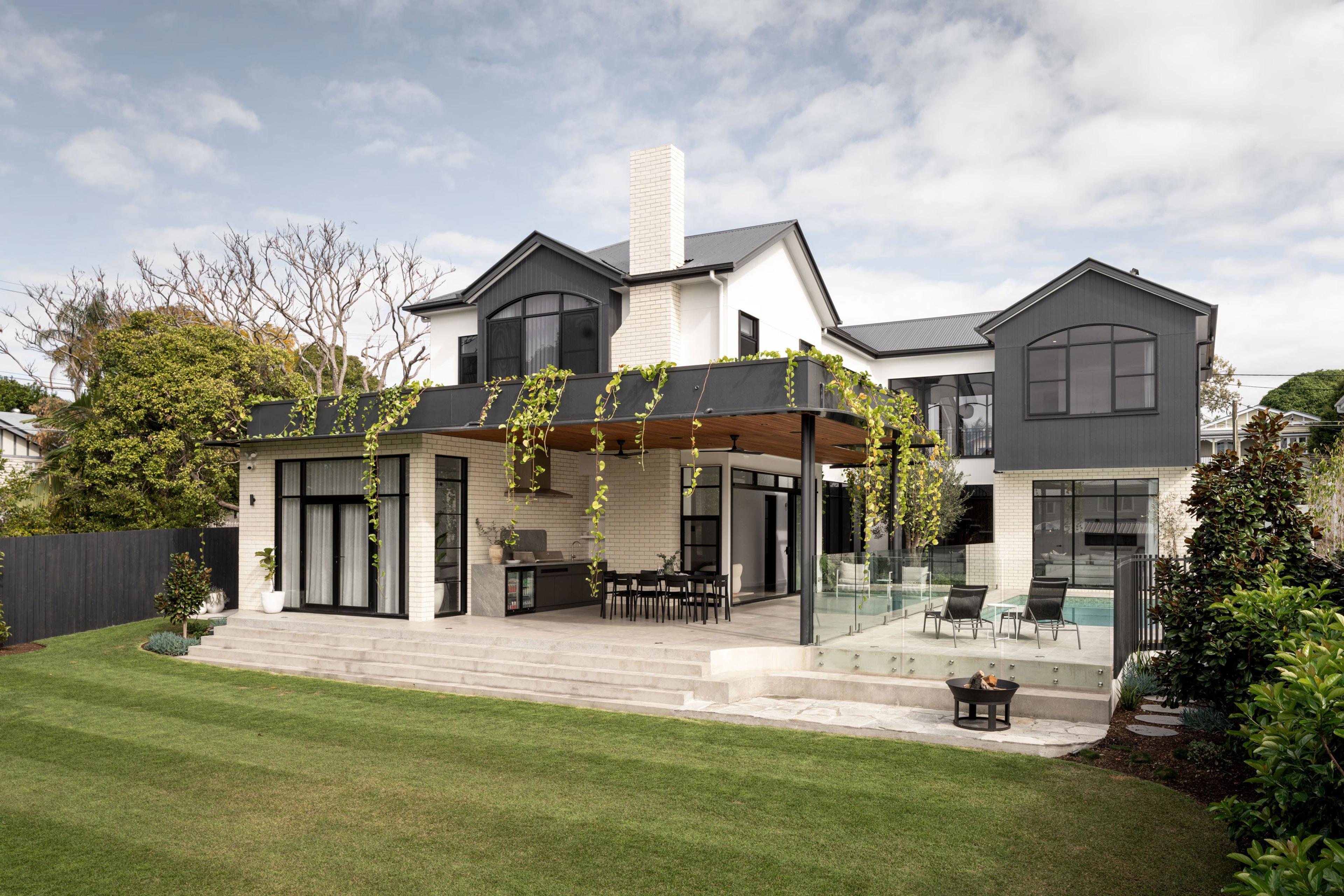 Rear elevation with covered terrace, pool and landscaped lawn