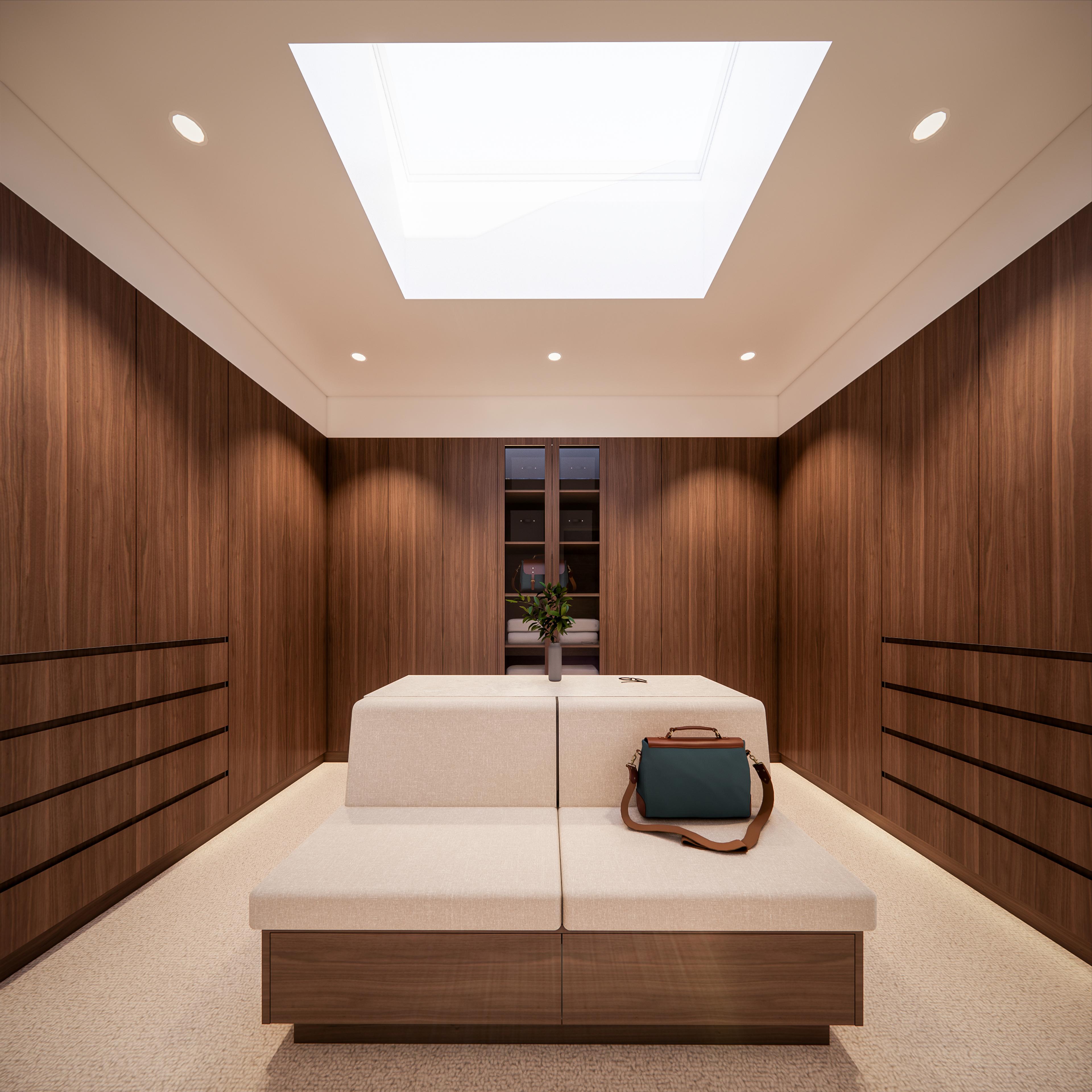 Walk-in wardrobe lined with walnut cabinetry, central upholstered ottoman and a large square skylight overhead