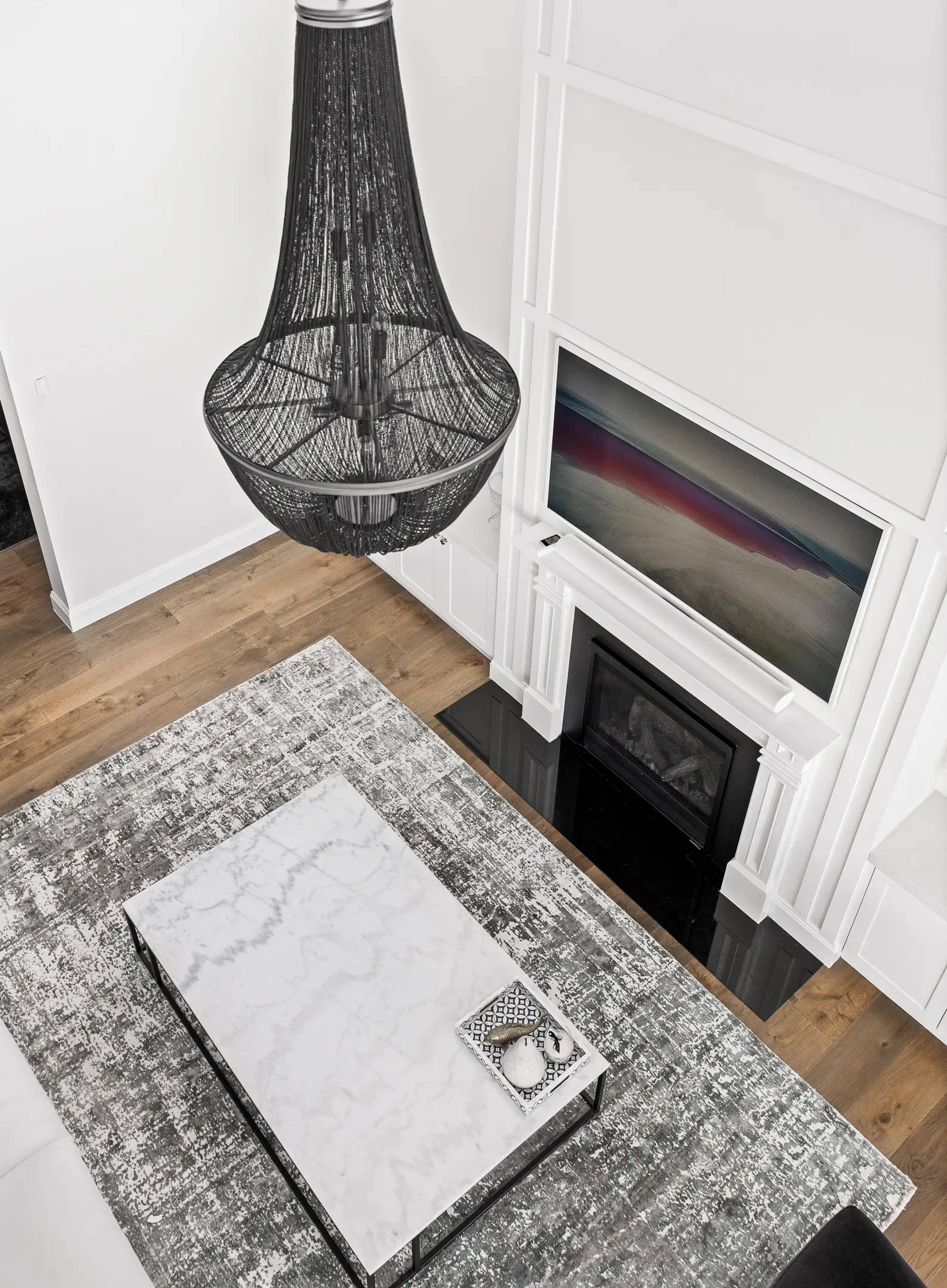 Living room from above with chandelier and marble table