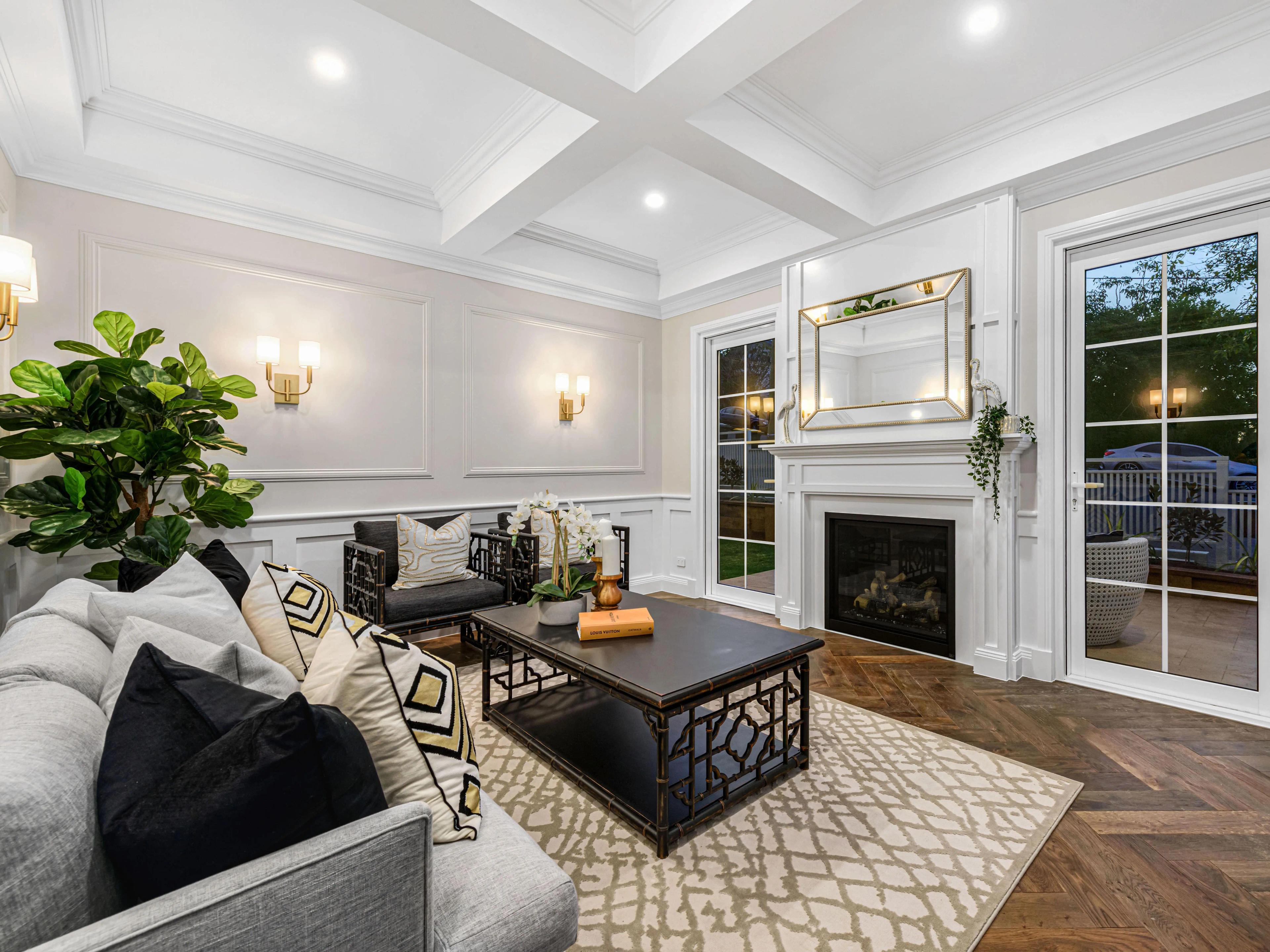 Formal lounge with fireplace and coffered ceiling