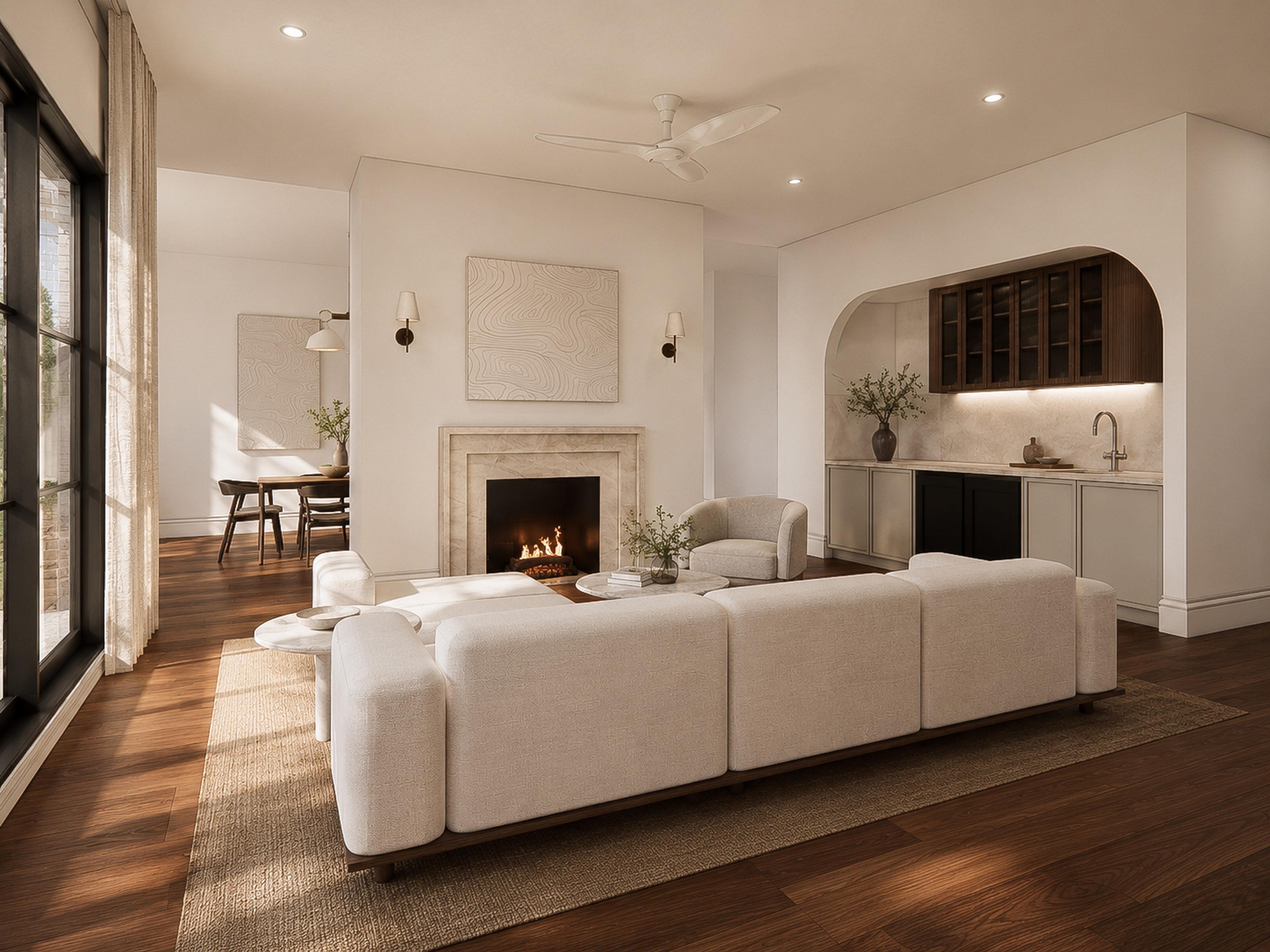 Open living room with white modular sofa, stone fireplace, timber floors and an arched joinery bar with wine cabinet