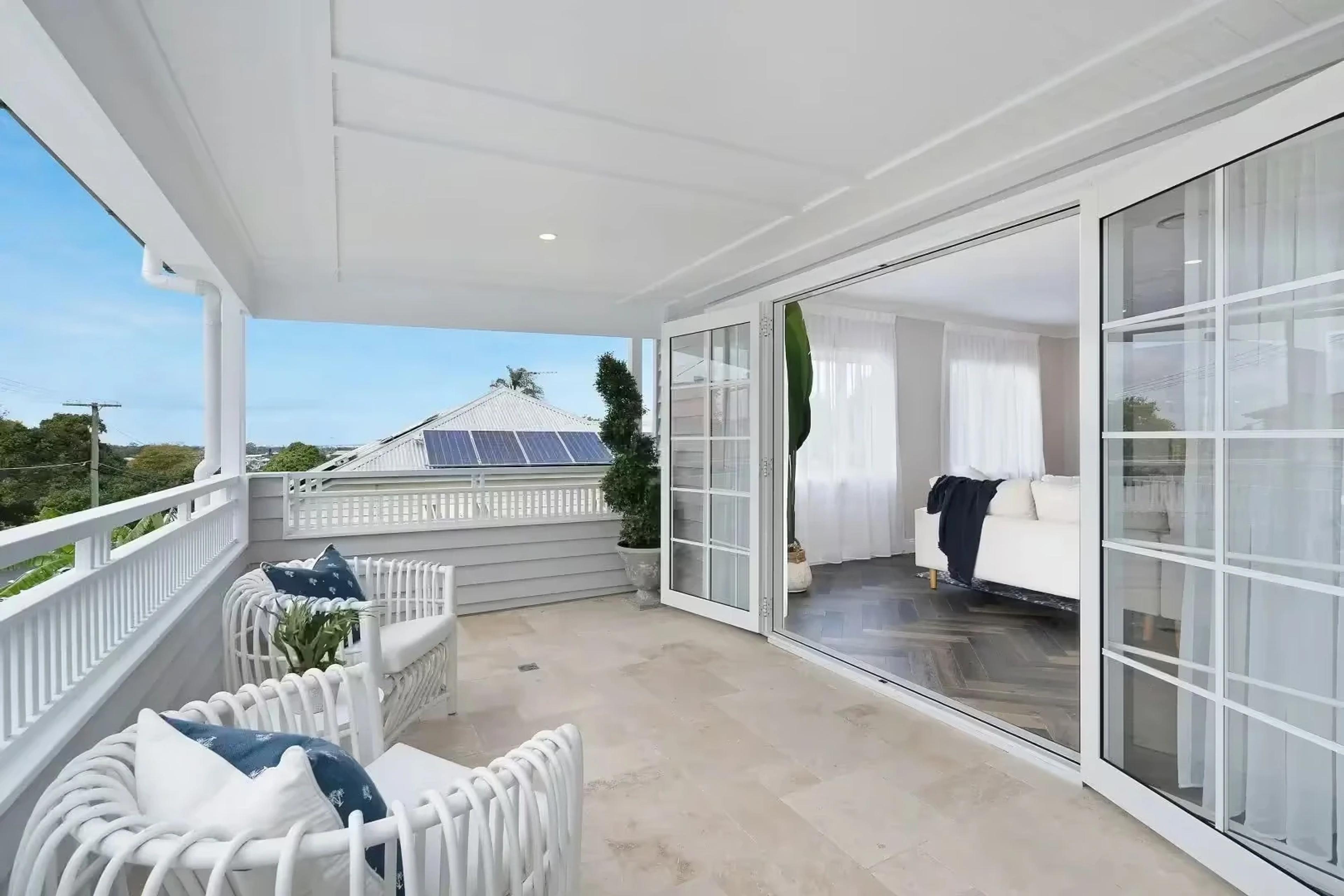 Upstairs balcony with cane chairs and bedroom access